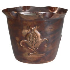 Antique Joseph Sankey & Sons. An Arts & Crafts copper planter with embossed flower pod