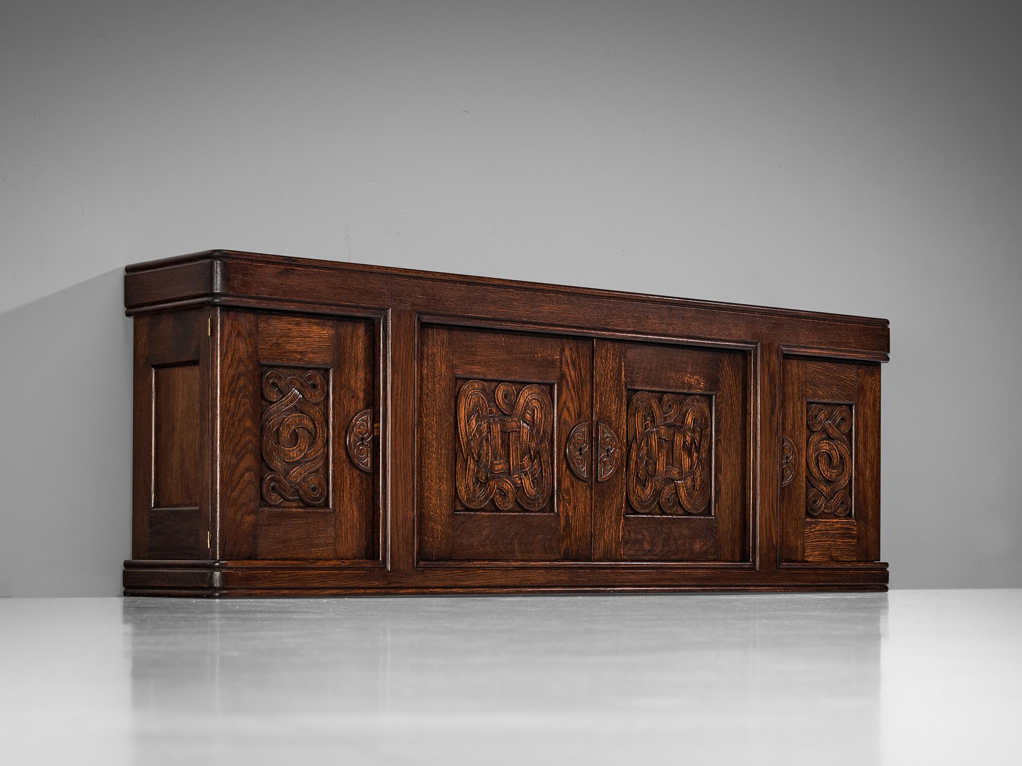 Joseph Savina, sideboard, oak, France, 1954

Designed by the Frenchman Joseph Savina, this cabinet is a testament to exquisite craftsmanship and profound artistry. The corpus is solidly built marked by distinct geometrical elements with a clear,
