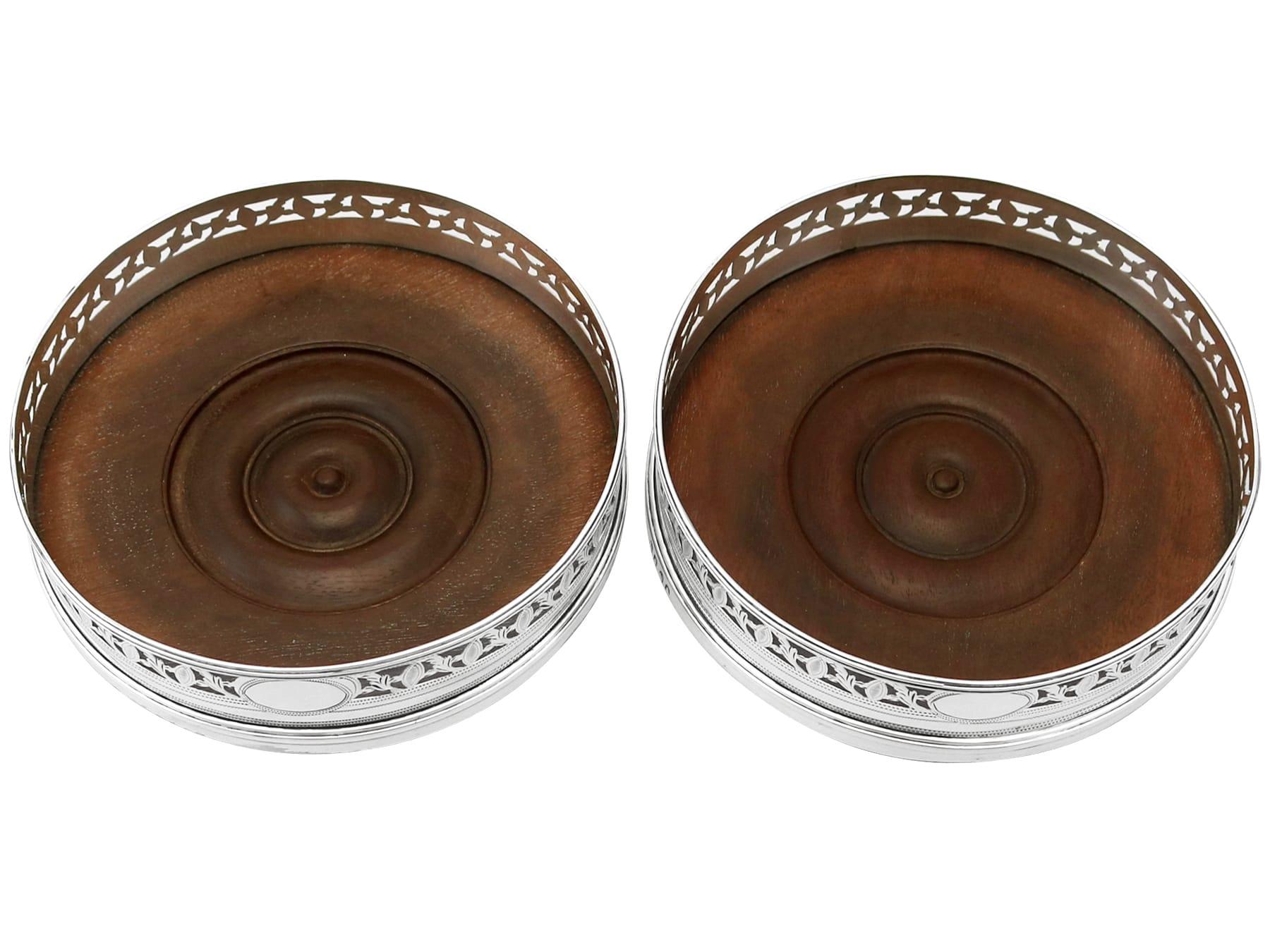 An exceptional, fine and impressive pair of antique Georgian English sterling silver coasters; part of our wine and drinks related silverware collection

These exceptional antique George III sterling silver wine bottle coasters have a circular