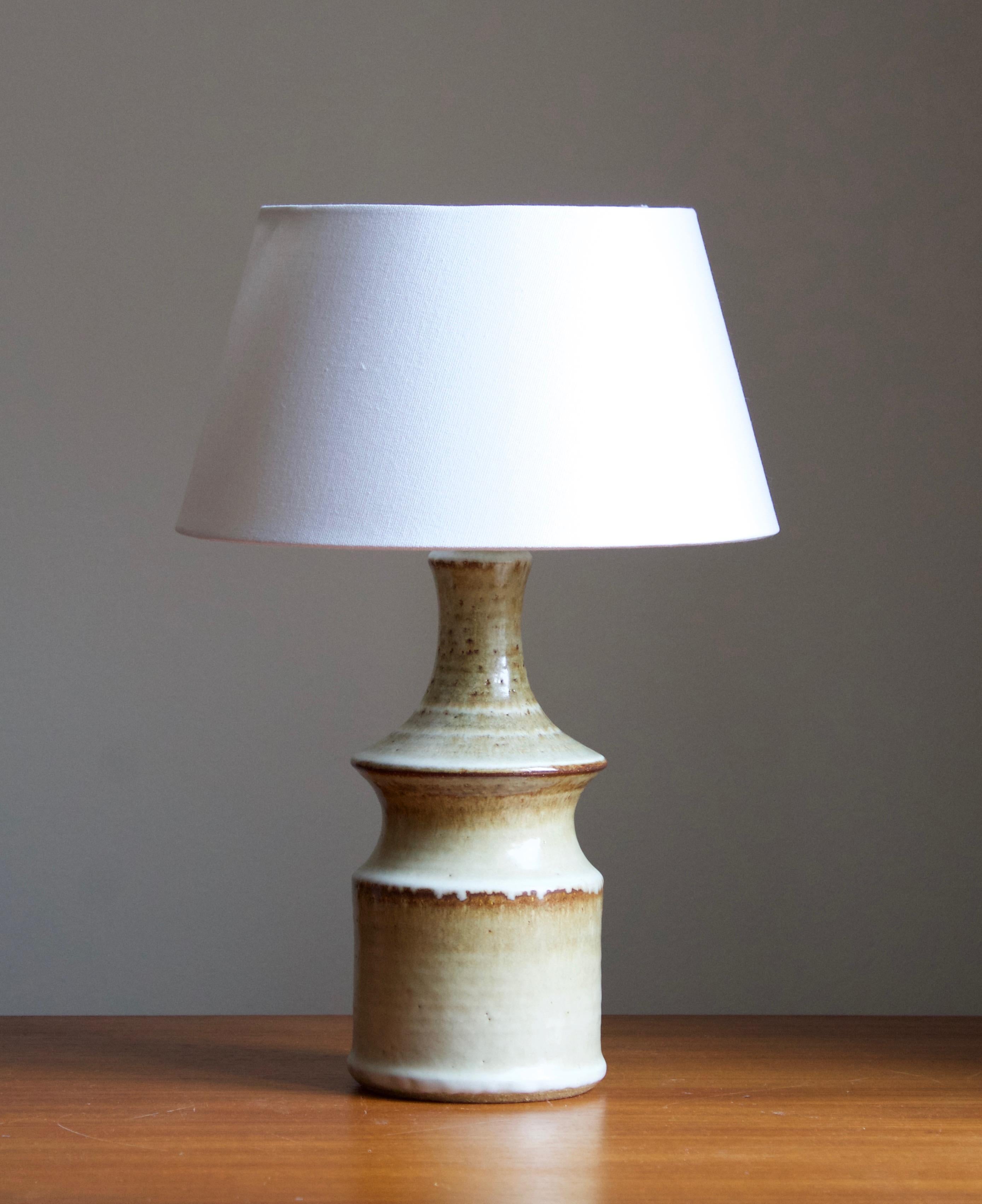 A large table lamp produced by Søholm Keramik, located on the island of Bornholm in Denmark. Features a highly artistic glazed decor. 

Sold without lampshade. Stated dimensions exclude the lampshade, height includes socket.

Glaze features