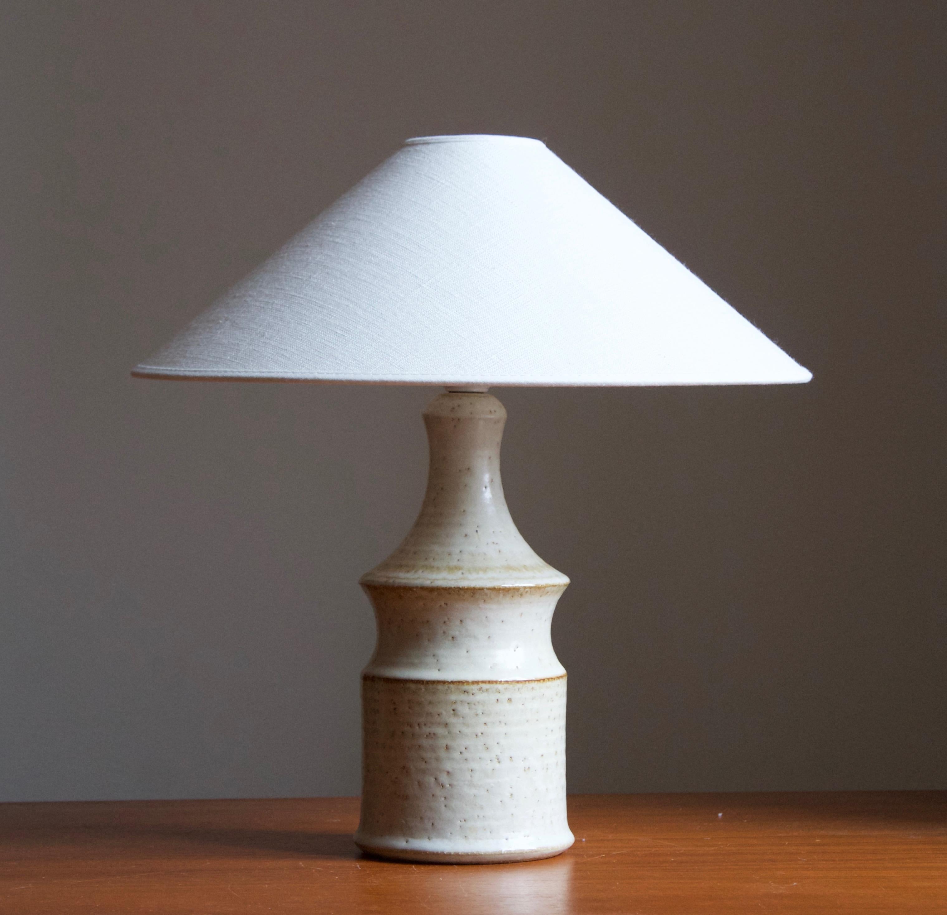 A table lamp produced by Søholm Keramik, located on the island of Bornholm in Denmark. Features a highly artistic glazed decor. 

Sold without lampshade. Stated dimensions exclude the lampshade, height includes socket.

Glaze features white-brown