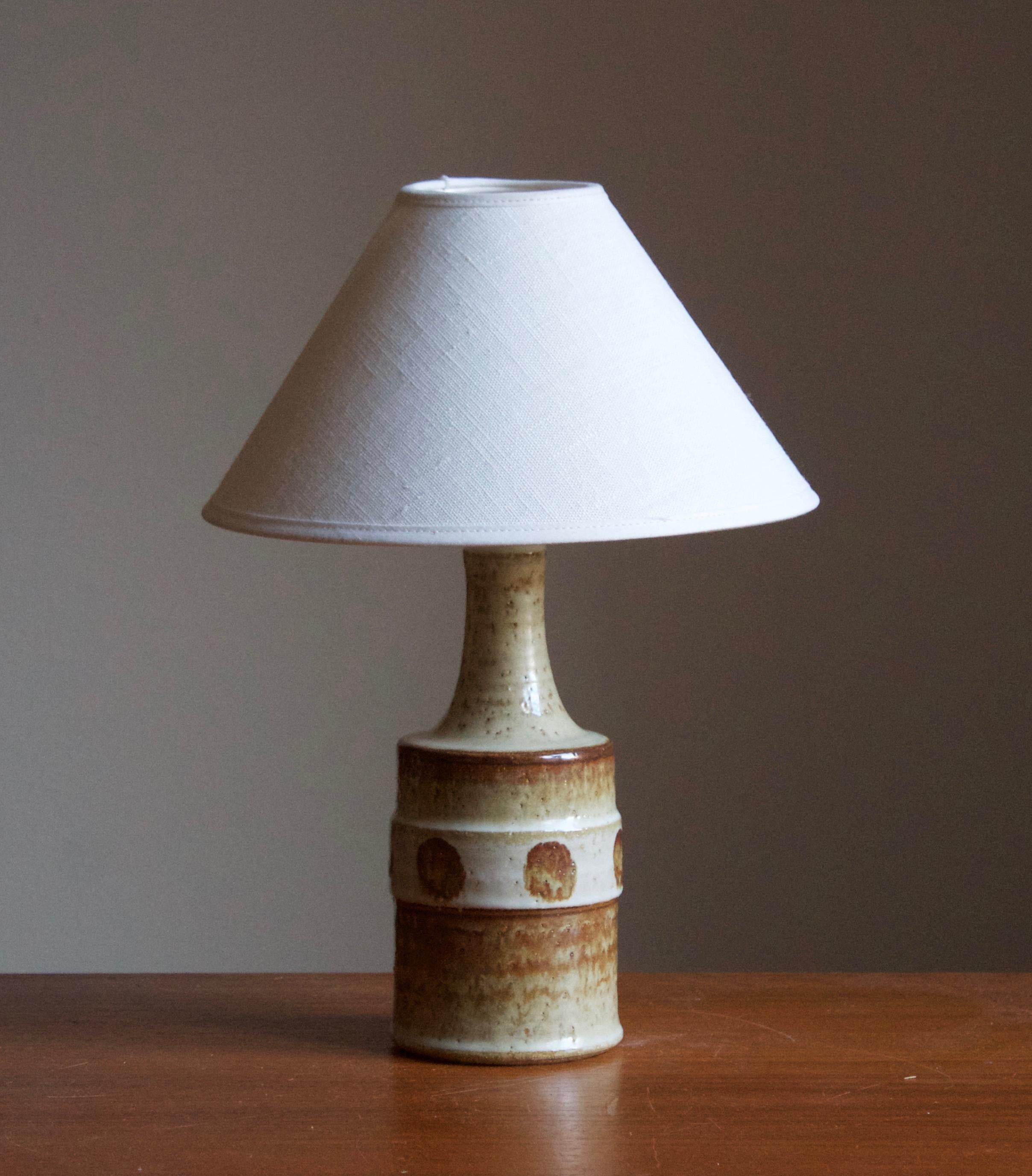 A table lamp produced by Søholm Keramik, located on the island of Bornholm in Denmark. Features a highly artistic glazed decor. 

Sold without lampshade. Stated dimensions exclude the lampshade, height includes socket.

Other designers of the