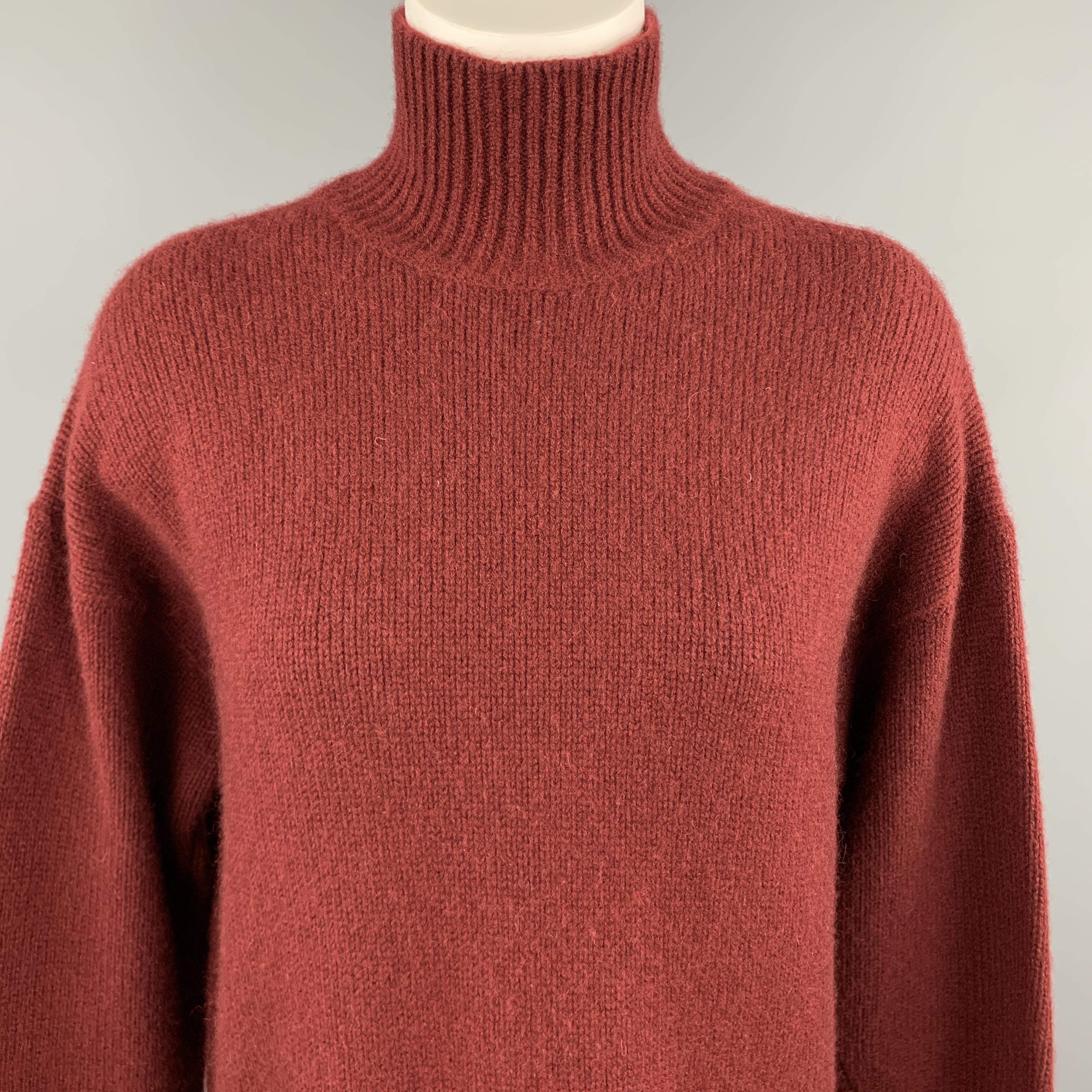 JOSEPH oversized turtleneck sweater comes in rich burgundy red cashmere knit with a ribbed high turtleneck, longline hem, and slit cuff sleeves. 

Excellent Pre-Owned Condition.
Marked: M

Measurements:

Shoulder: 22 in.
Bust: 46 in.
Sleeve: 24