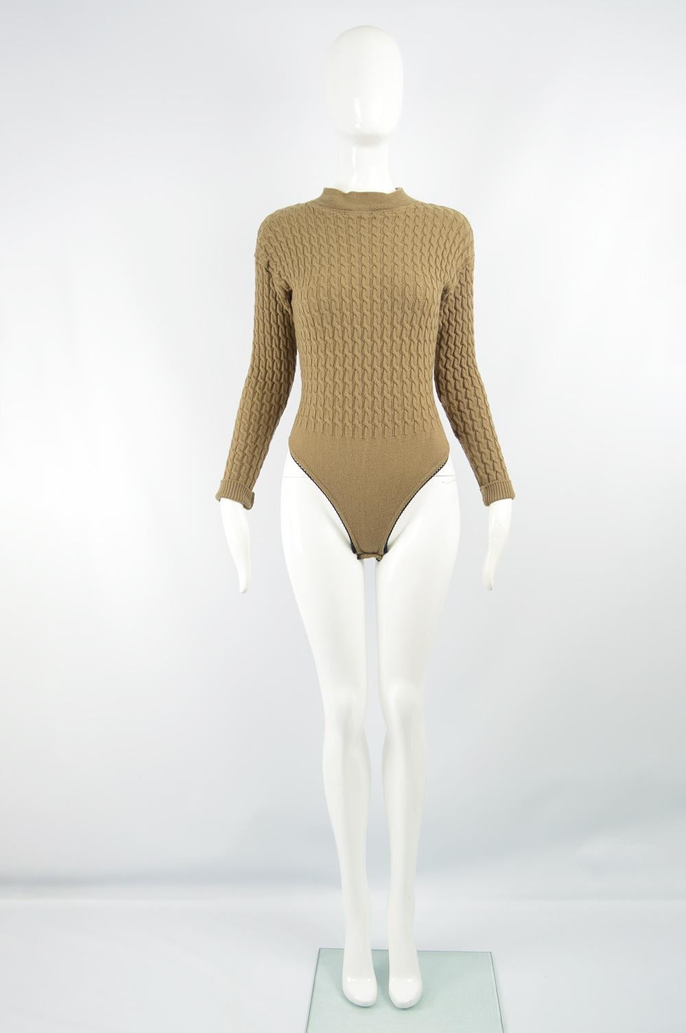 A chic vintage women's bodysuit from the 90s by luxury British fashion label, Joseph for the highly collectable Tricot line. In a brown wool chain cable knit with a mock neck and turn back cuffs. 

Size: Marked M but also fits Small. Please check