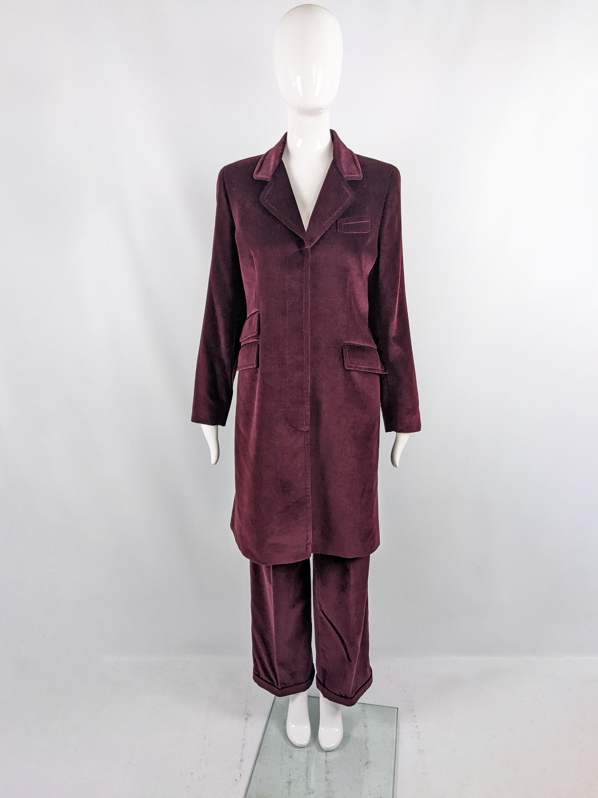 An incredible and rare vintage womens two piece suit from the 90s by luxury British fashion house, Joseph. In a wine red velvet, consisting of an amazing, longline blazer jacket that has concealed, fly-front buttons and matching high waisted, wide