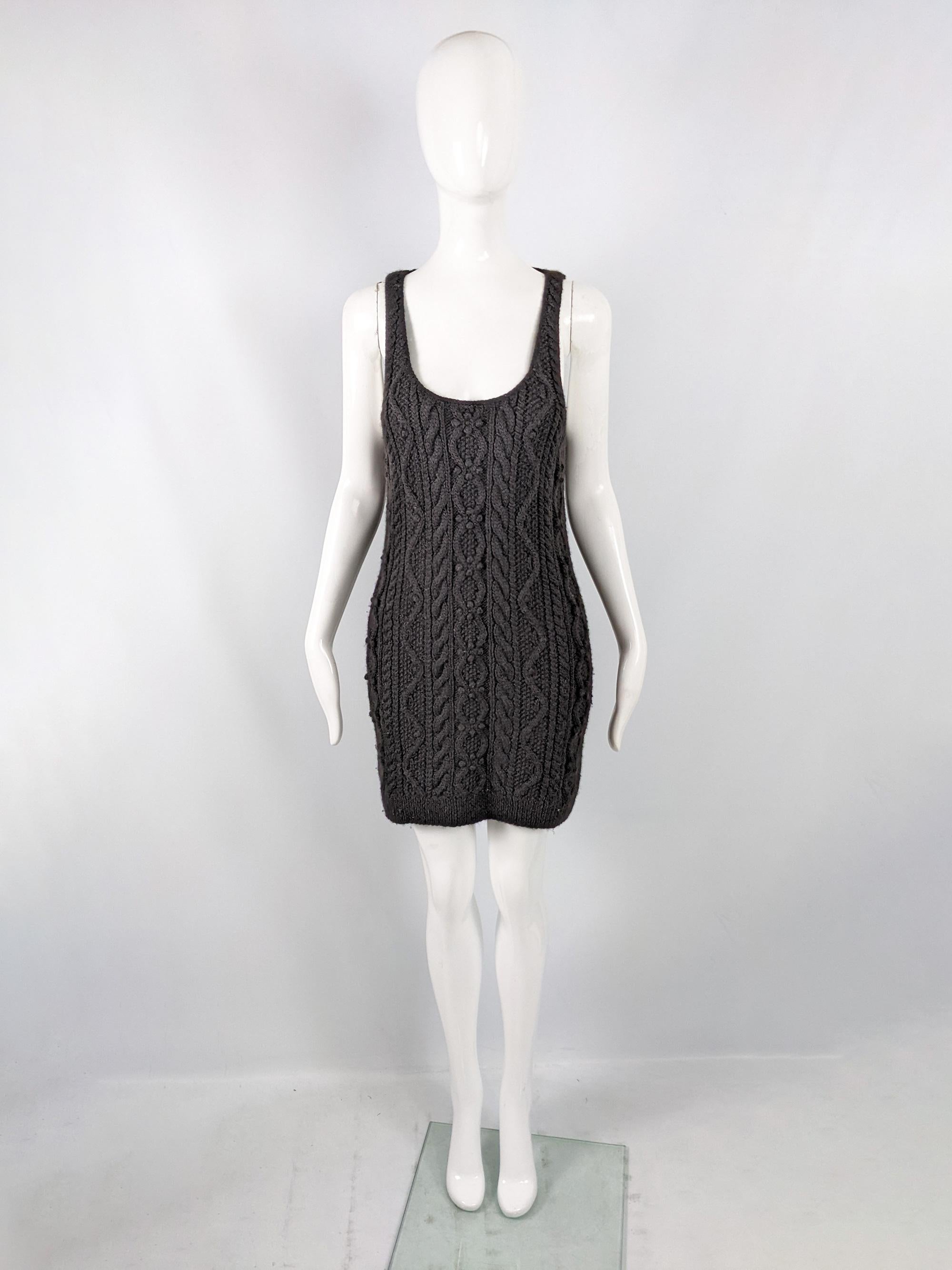 A chic vintage womens dress from the late 90s by luxury British fashion designer, Joseph. Hand knit, in a black wool cable knit fabric with a deep scoop neck and low sides which would make it perfect as a pinafore dress.

Size: Marked S. Please