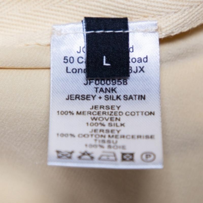 Make Joseph the default option when it comes to choosing which top to dress up in for any occasion. This jersey & satin tank top carries a lovely shade of yellow. It has a rounded neckline and side button detailing. Pair with denims and trousers