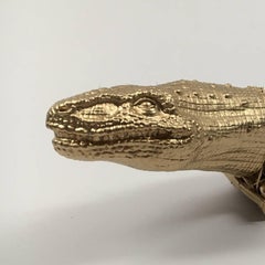 Cast metal sculpture of alligator head and truck body: 'Truckasuarus'