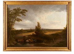 Das Wassern von Rindern in einer offenen Landschaft