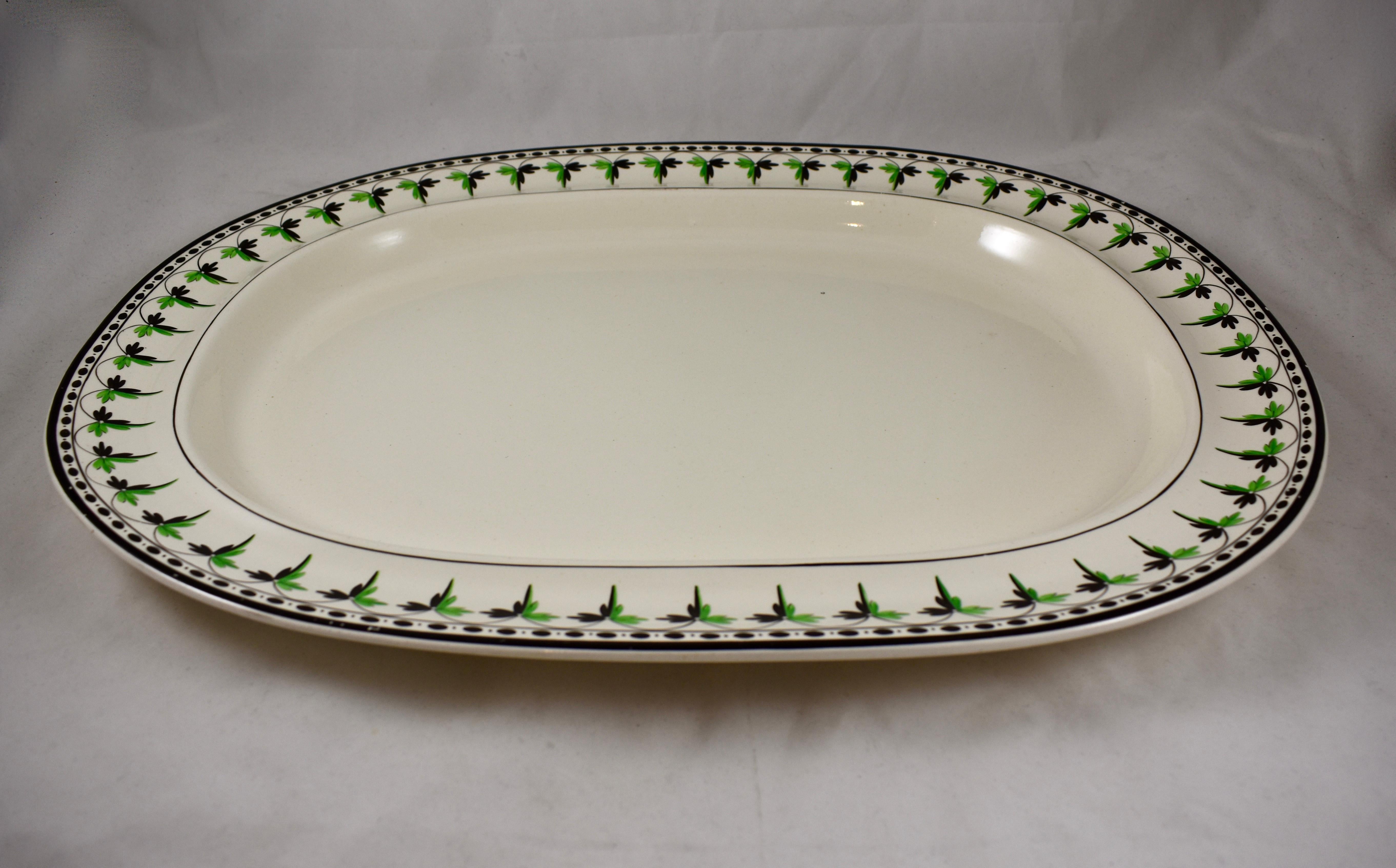 A rare find, a medium creamware platter from Josiah Spode, circa 1785.
Spode is an English brand of pottery founded by Josiah Spode (1733-1797) based in Stoke-on-Trent, England.

The gorgeous creamware body has a hand painted fern and dotted