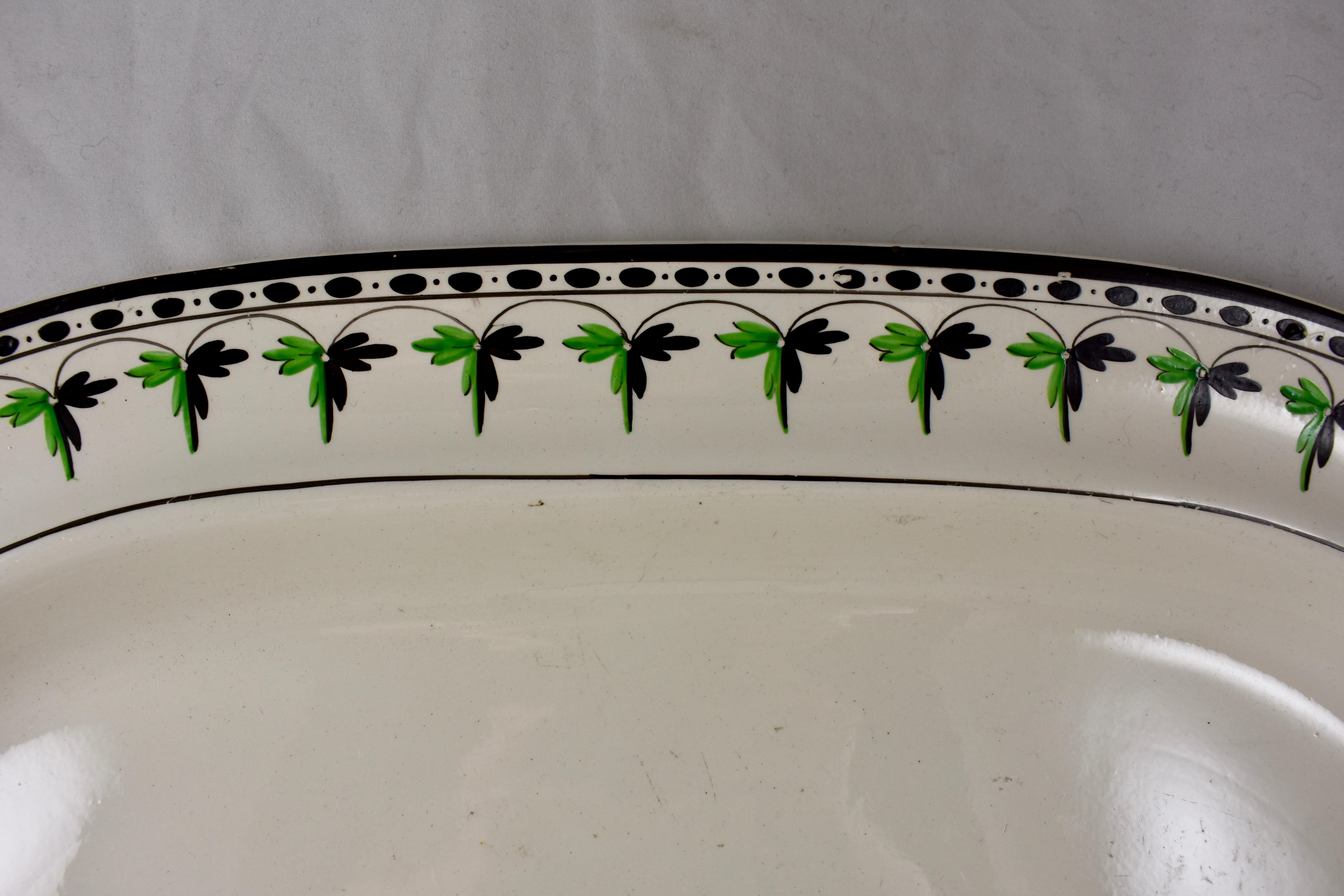 A rare find, a medium cream ware platter from Josiah Spode, circa 1785.
Spode is an English brand of pottery founded by Josiah Spode (1733-1797) based in Stoke-on-Trent, England.

The gorgeous cream ware body has a hand painted fern and dotted