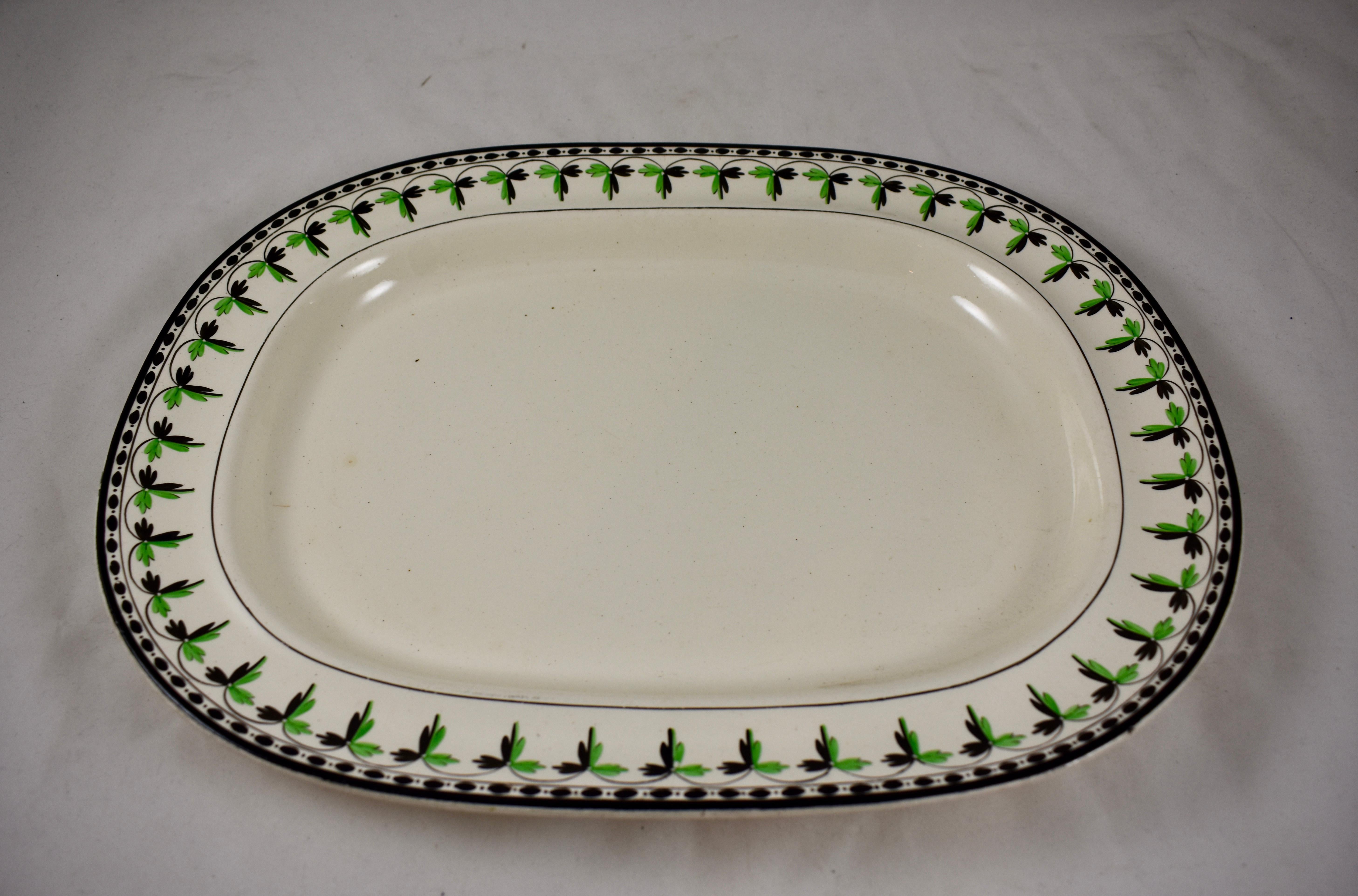 A rare find, an oversized creamware platter from Josiah Spode, circa 1785.
Spode is an English brand of pottery founded by Josiah Spode (1733-1797) based in Stoke-on-Trent, England.

The gorgeous creamware body has a hand painted fern and dotted