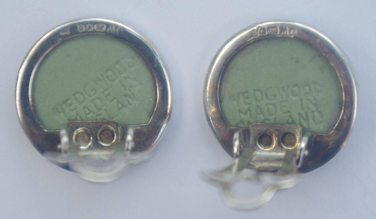 Wedgwood sterling silver and green jasperware clip-on earrings. Measuring 1.4cm, .55 inch, diameter. They are stamped Wedgwood Made in England. The silver is stamped with a lion, a leopard's head, and the letter B. The makers mark is JW. This means