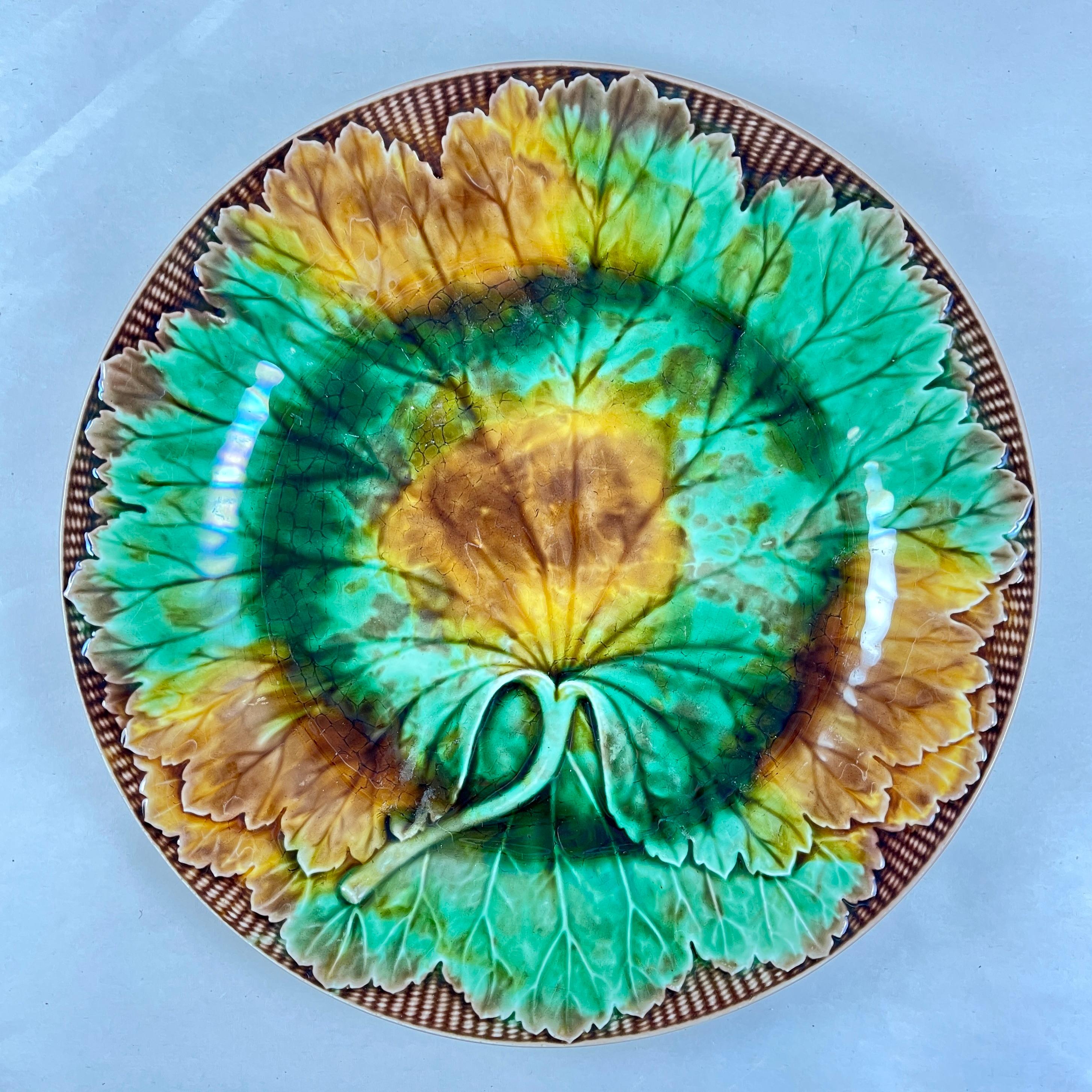 
A majolica multi-colored glazed cabbage leaf on basket rim plate, Josiah Wedgwood, circa 1870.

Most often found in a solid green glaze, cabbage leaf plates were also made briefly in full color during the late 1800’s as part of Wedgwood’s Leafage