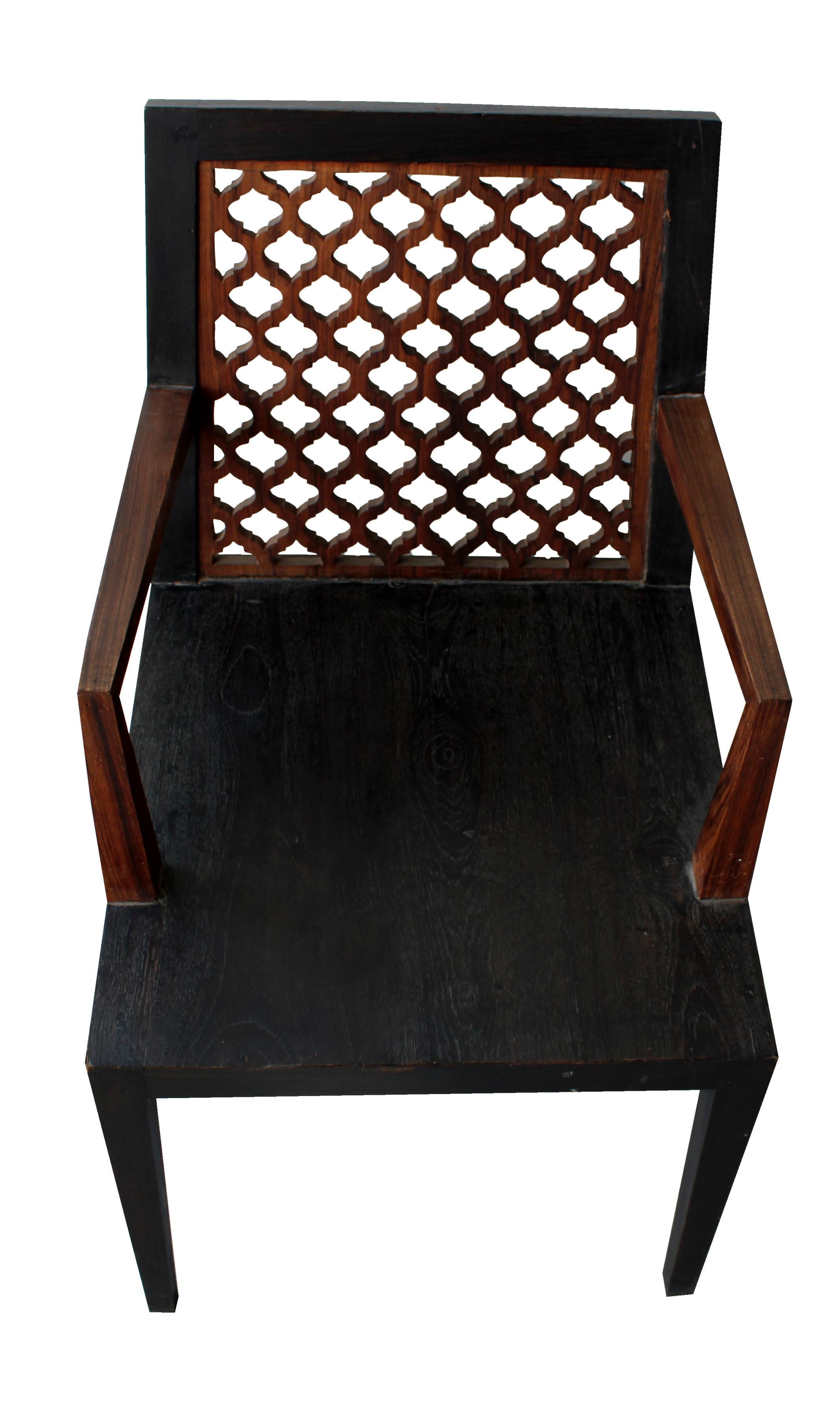 Inspired by the elegant pierced Jali pattern in the architecture he observed in and around Rajasthan, renowned designer Paul Mathieu designed this elegant char. This elegant chair is handmade from solid pieces of teak that are framed and carved to