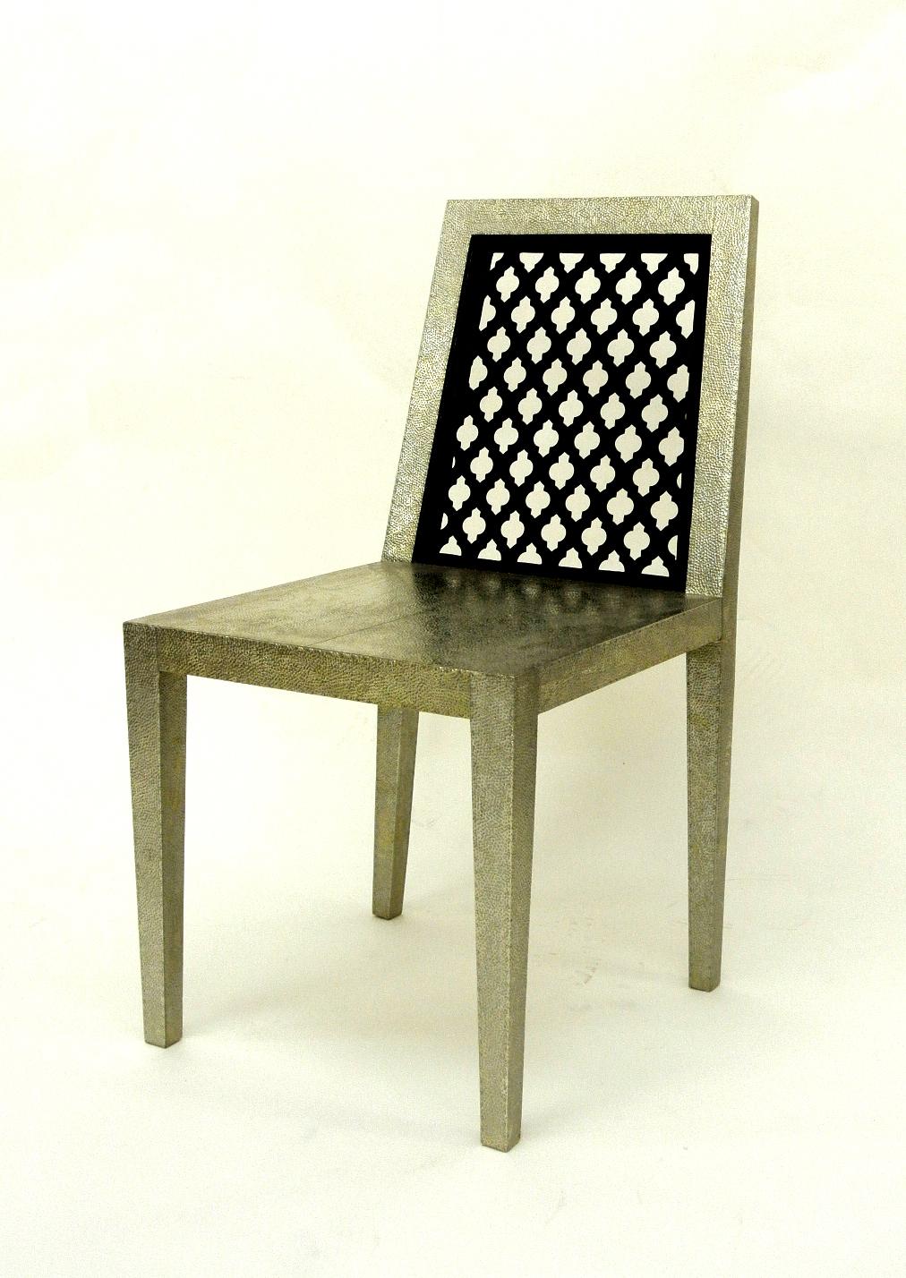 Inspired by the elegant pierced Jali pattern in the architecture he observed in and around Rajasthan, renowned designer Paul Mathieu designed this elegant char. This elegant chair is handmade from solid pieces of teak that are framed and carved to