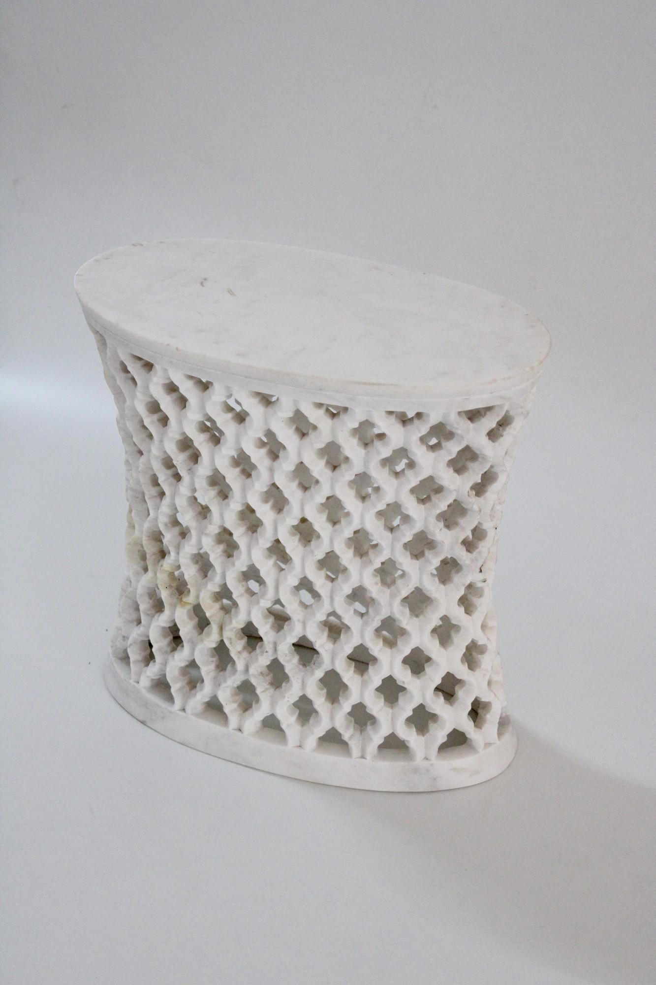 Inspired by the elegant pierced marble “jali” screens and windows he saw in the palaces of Mughal India, the renowned designer Paul Mathieu created a unique collection of hand carved side table.
 
Solid blocks of marble are hollowed out and hand