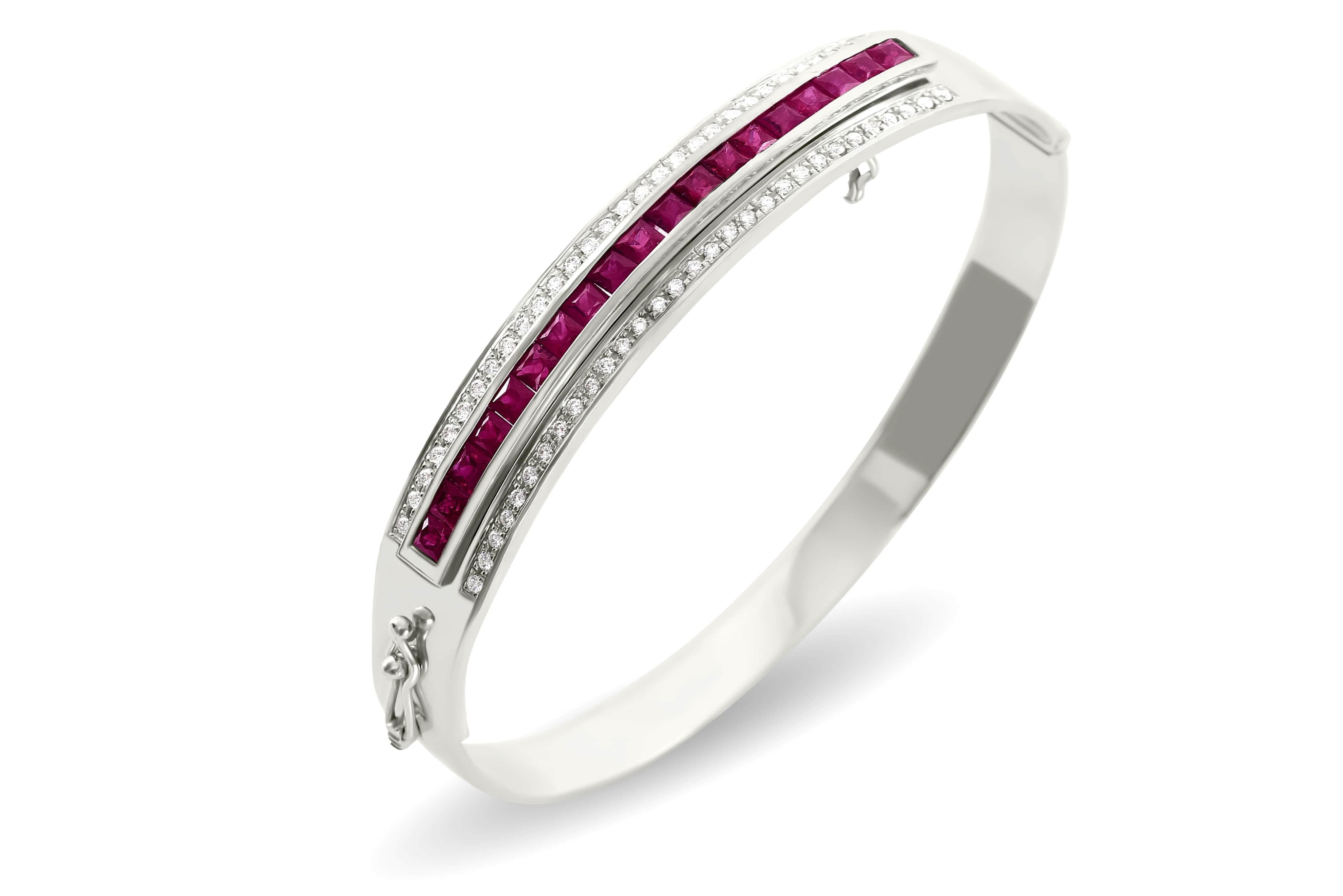 This decadent piece features the highest quality brilliant cut diamonds set in solid platinum in an elegant hinged oval bangle. The featured gemstone insert of your choice is interchangeable, set with magnificent hand selected, calibrated blue