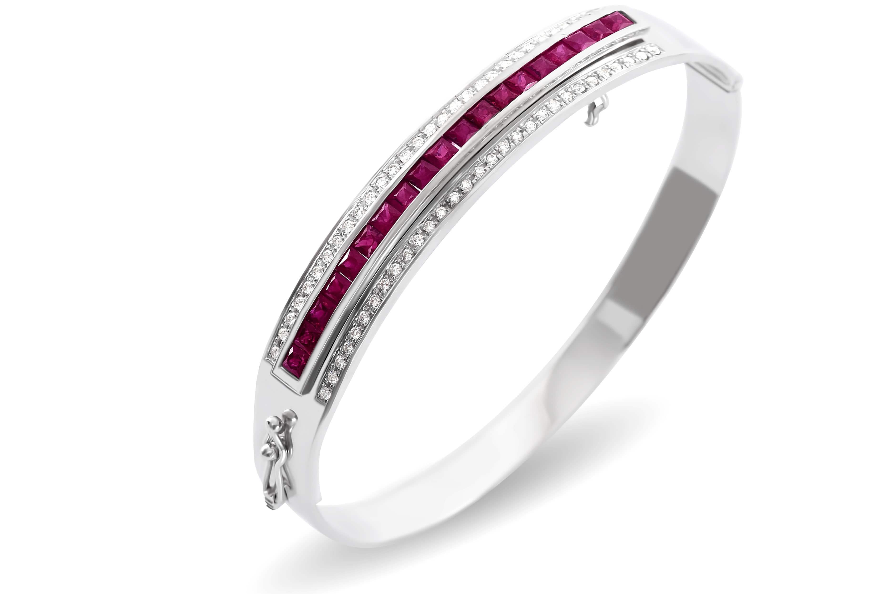 This decadent piece features the highest quality brilliant cut diamonds set in solid 18k white gold in an elegant hinged oval bangle. The featured gemstone insert of your choice is interchangeable, set with magnificent hand selected, calibrated blue