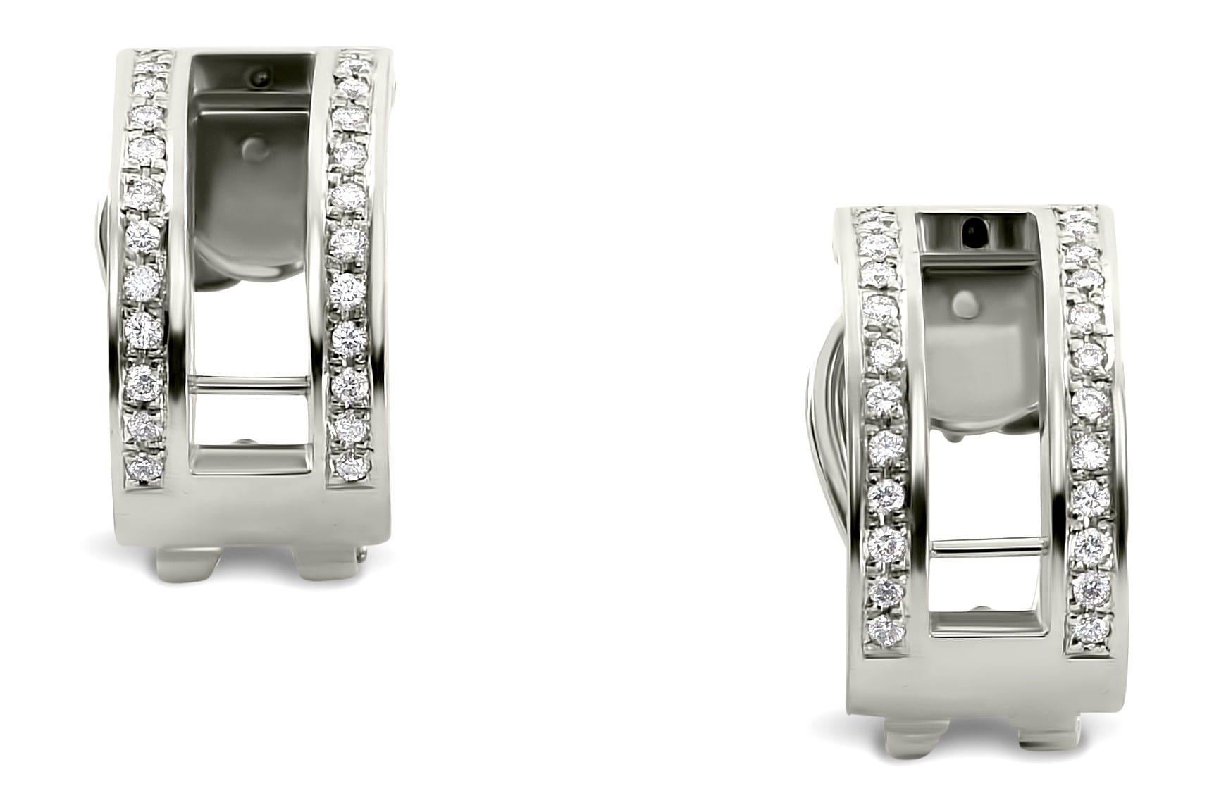 These exquisite hand crafted earrings feature two rows of the finest available brilliant cut diamonds, set in solid 18k white gold. Each insert boasts hand selected rubies, tsavorites and sapphires in a calibrated setting. The ingenious design