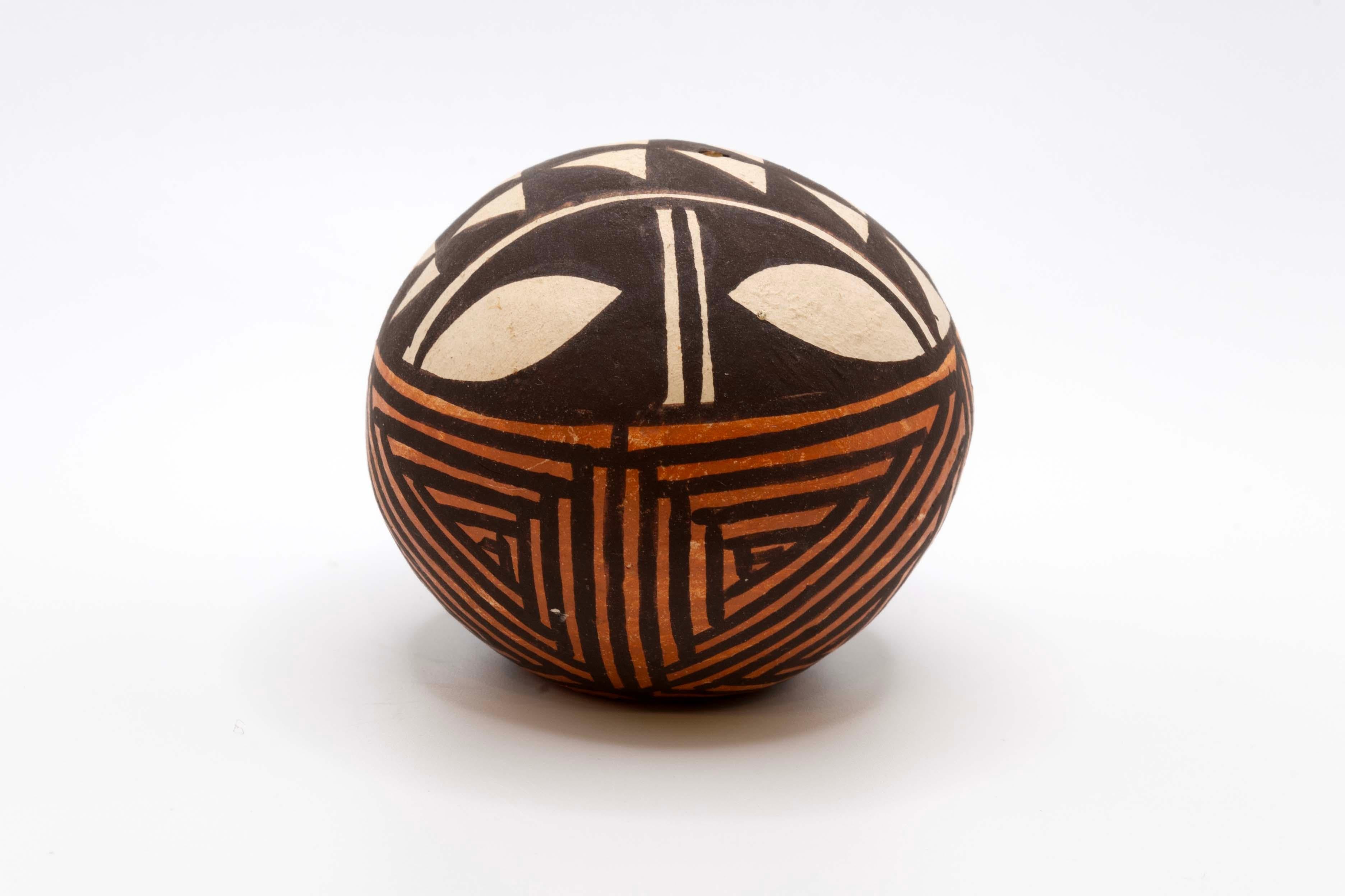 A mini set of Pueblo Acoma & Santa Clara pottery from New Mexico. Each vessel is signed with a different artist’s signature: Joyce L (Joyce Leno), Unknown (no signature), J-Teba (Jeanette Teba), and DG. The vessels are fired earthenware and carved