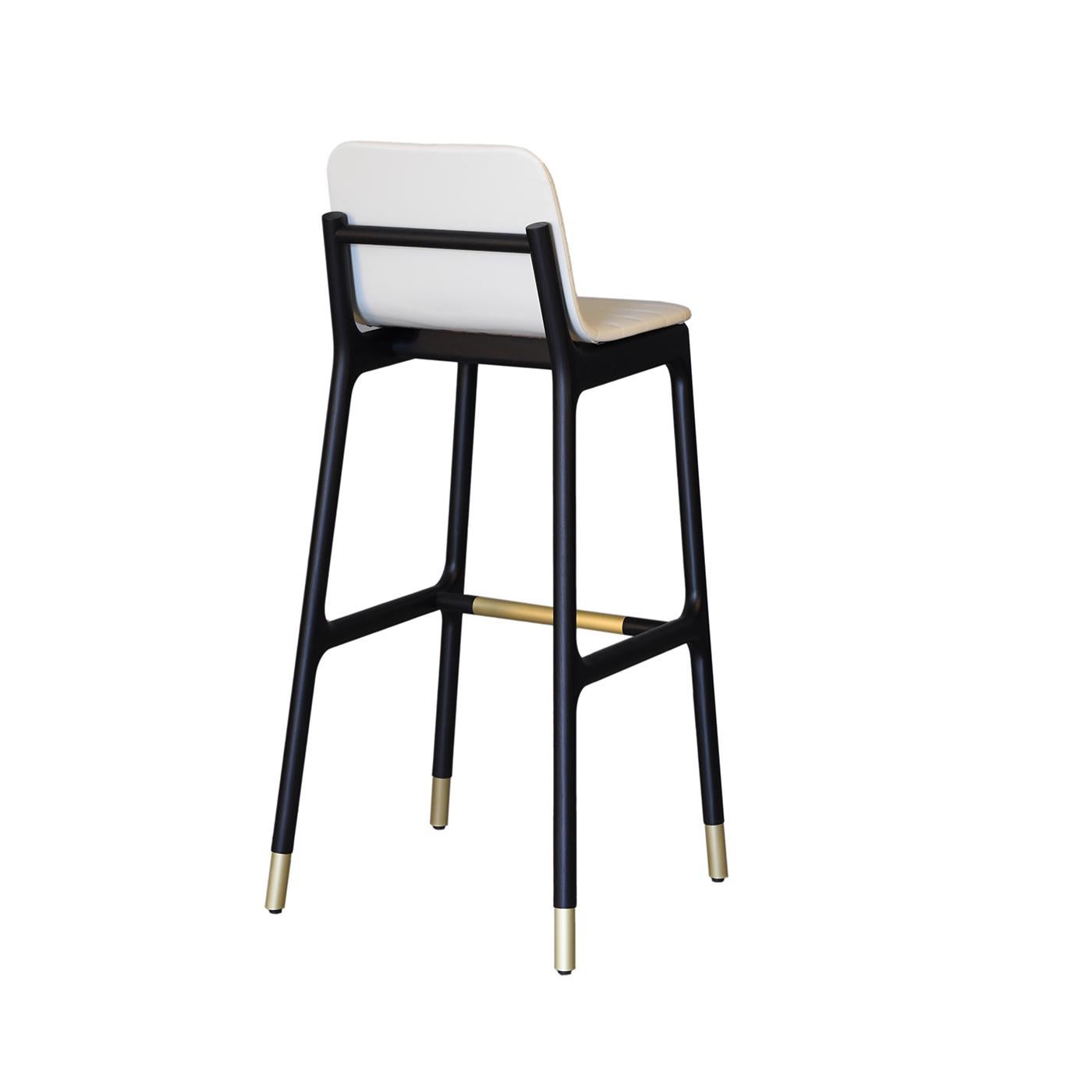 The Joyce collection represents a blend of past and present, innovation and tradition in the attempt to shape objects designed to last over time. The bar stool in ashwood features an upholstered seat and brass tips, pursuing the values of