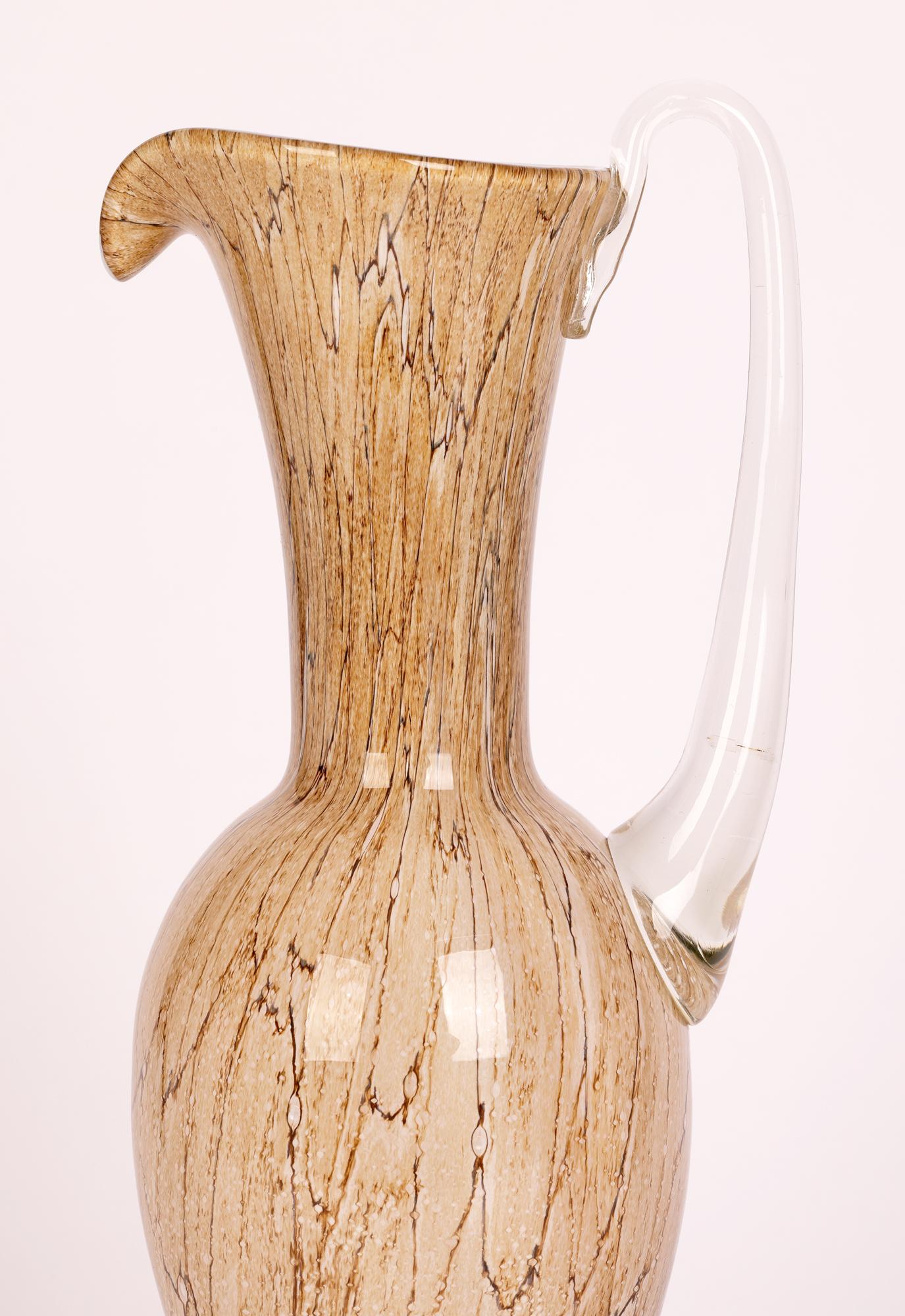 A stunning tall and elegant hand-blown Polish art glass jug attributed to the Jozefina Glass Makers, Krosno and dating from around 1980.

The Josefina factory was founded in Krosno, Poland in 1980 by Jozef Jankowski, a renowned artist and glass