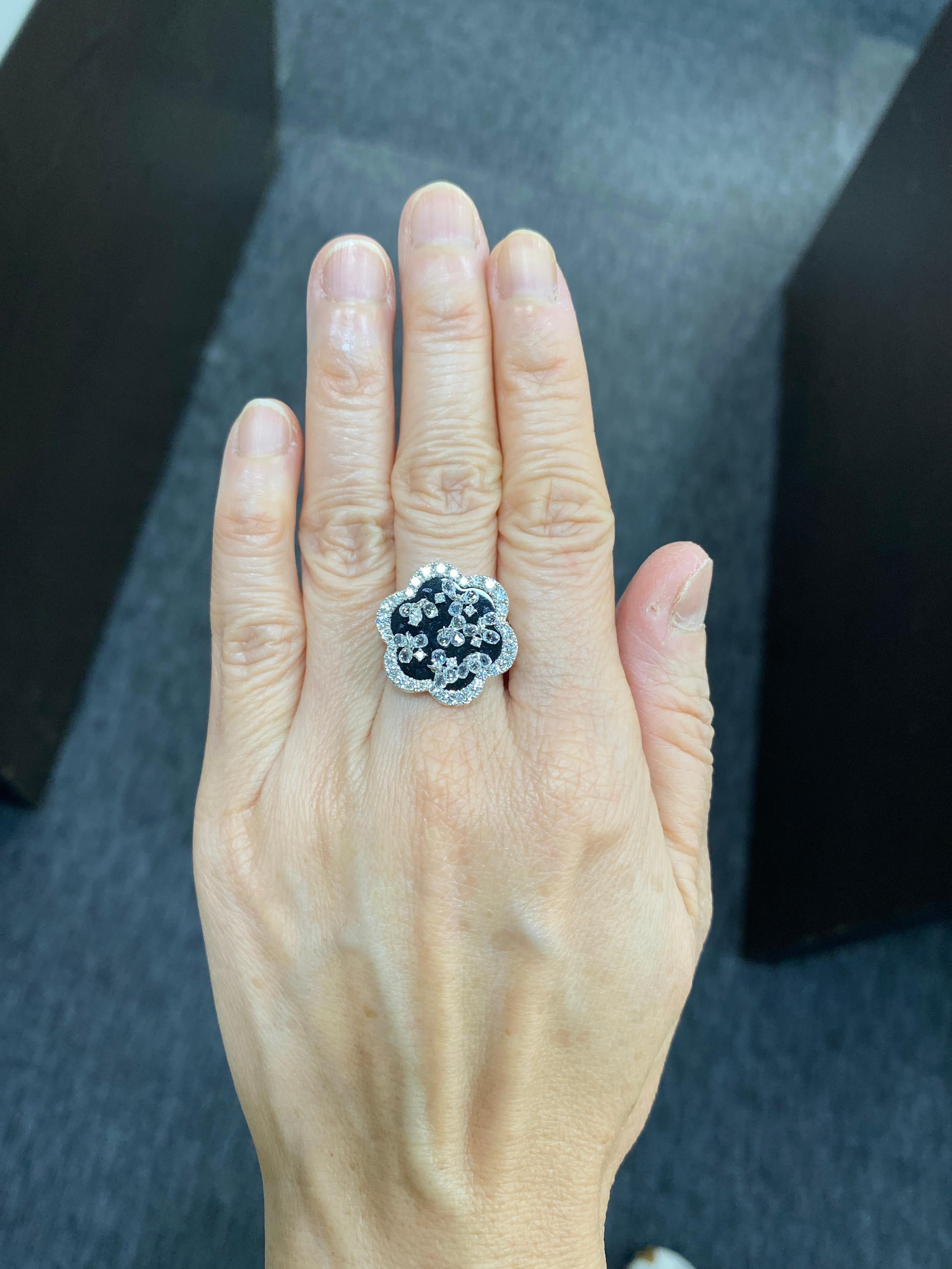 JR Briolette Diamond and Onyx Flower 18 Karat White Gold Ring

Our eccentric flower dangling diamond Briolettes ring is an absolute show-stopper. The Briolette diamonds & Onyx used in it enhances it's look by many folds. 

Ring Size Europe 54 (US