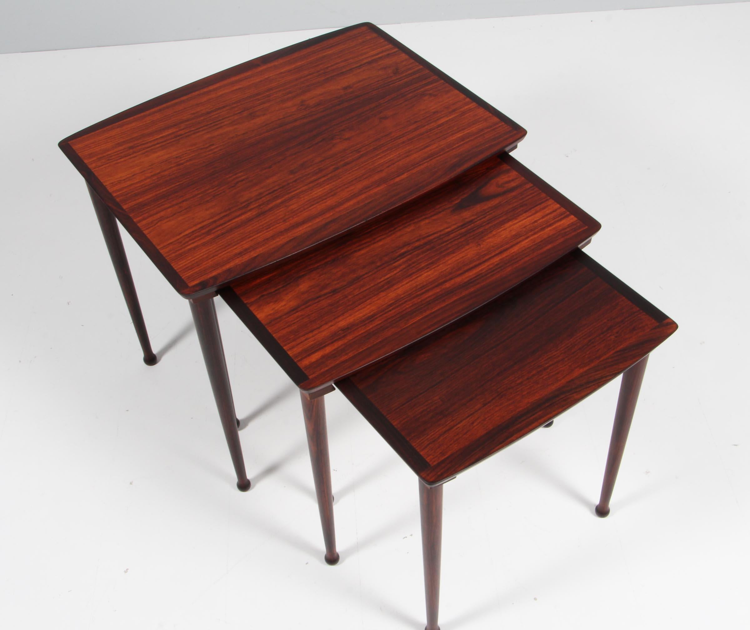 Jørgen Aakjær set of three nesting tables in rosewood, with solid rosewood drumstick legs.

Made in Denmark in the 1960s.