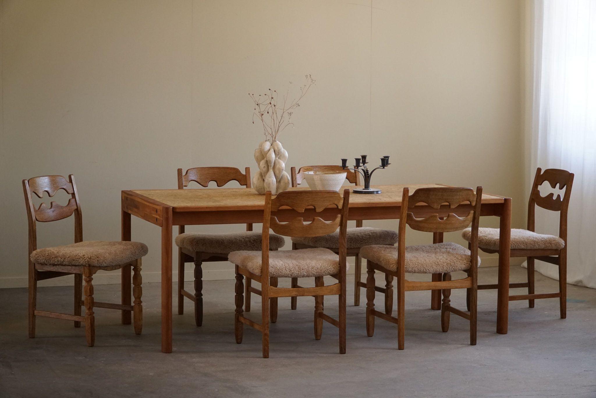 This rectangular dining table is a great example of Danish Mid Century Modern design, designed by Jørgen Bækmark for FDB in the 1960s. Crafted with meticulous attention to detail, it marries the warmth of oak with the unique texture of cork. The