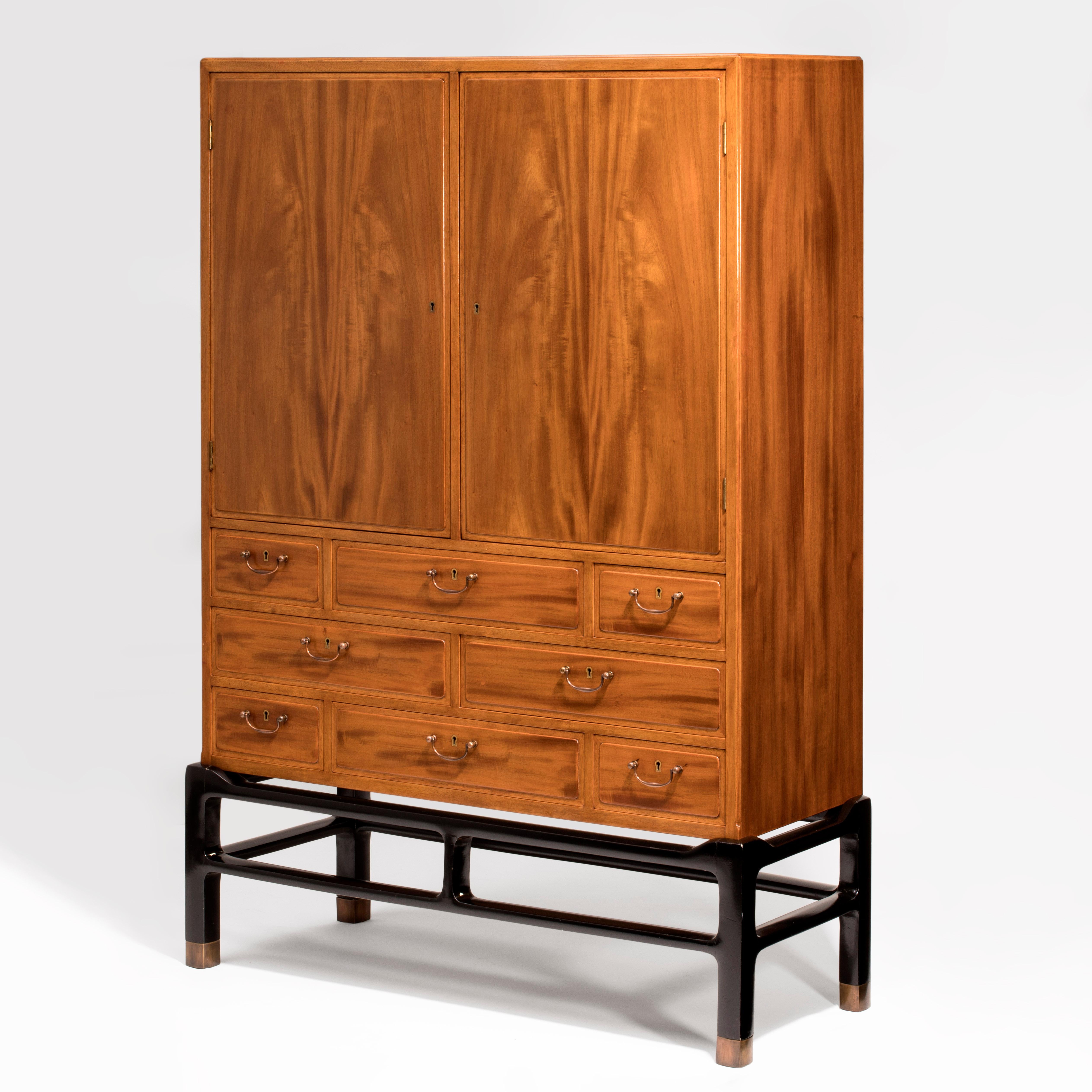 A fine example of Danish craftsmanship, handmade and beautifully detailed by master cabinetmaker William Christensen. The cabinet is a rare example; it is the only known piece by Berg executed in carefully selected, silky, fine-grained Honduras