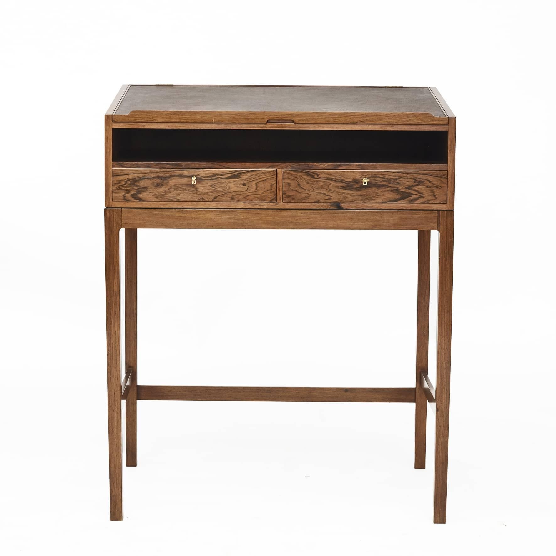 Jørgen Berg.
Danish writing desk in Rio rosewood.
Fall-front fitted with a writing slope with brown leather that lifts up to reveal an open interior storage compartment. Under the sloped top is a storage space above 2 drawers.
Raised on four