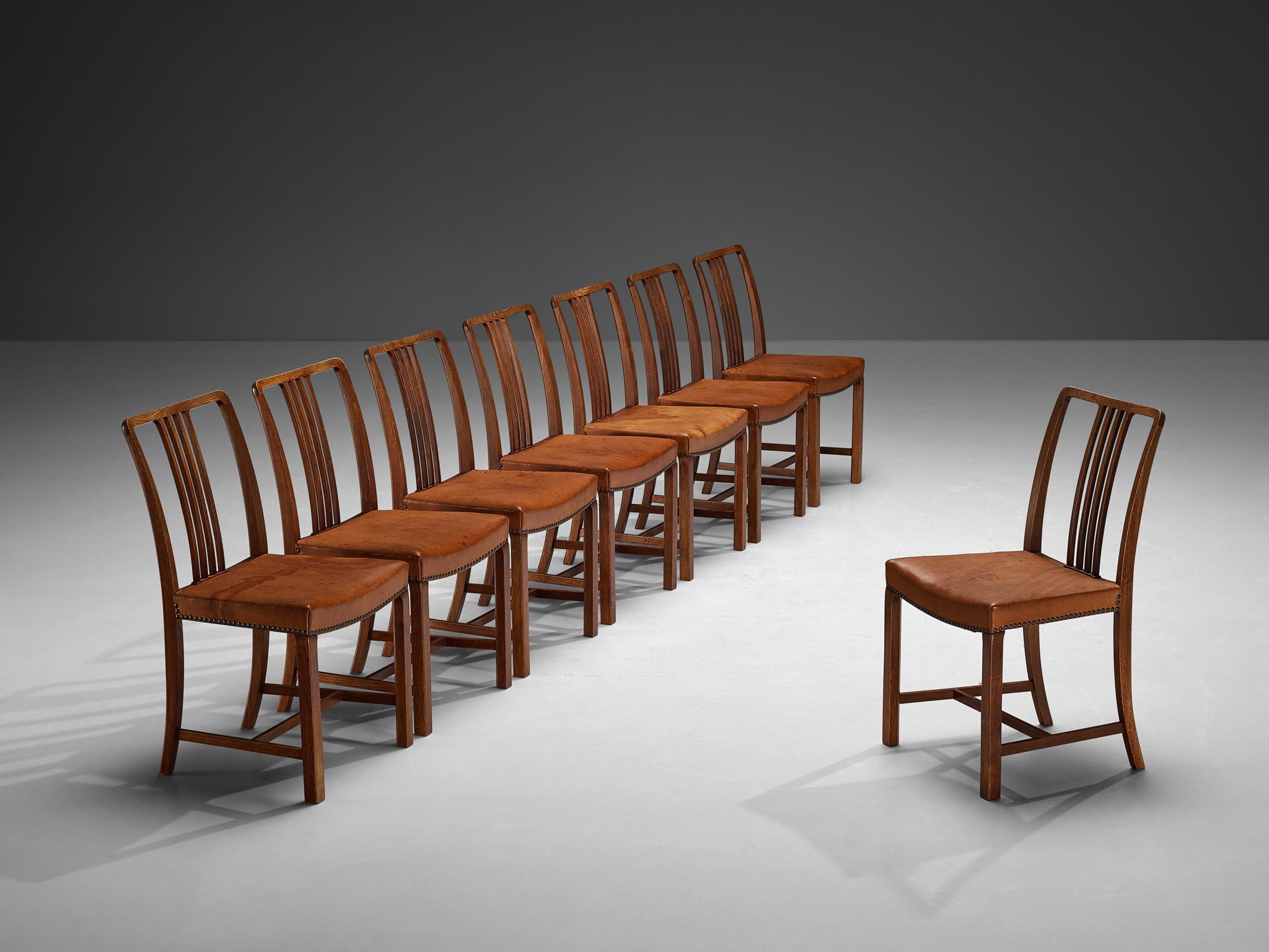 Jørgen Christensen, set of eight dining chairs, leather, oak, brass, Denmark, 1950s 

Exclusive set of eight dining chairs designed by Danish designer and cabinetmaker Jørgen Christensen. The seats are upholstered with patinated natural leather and