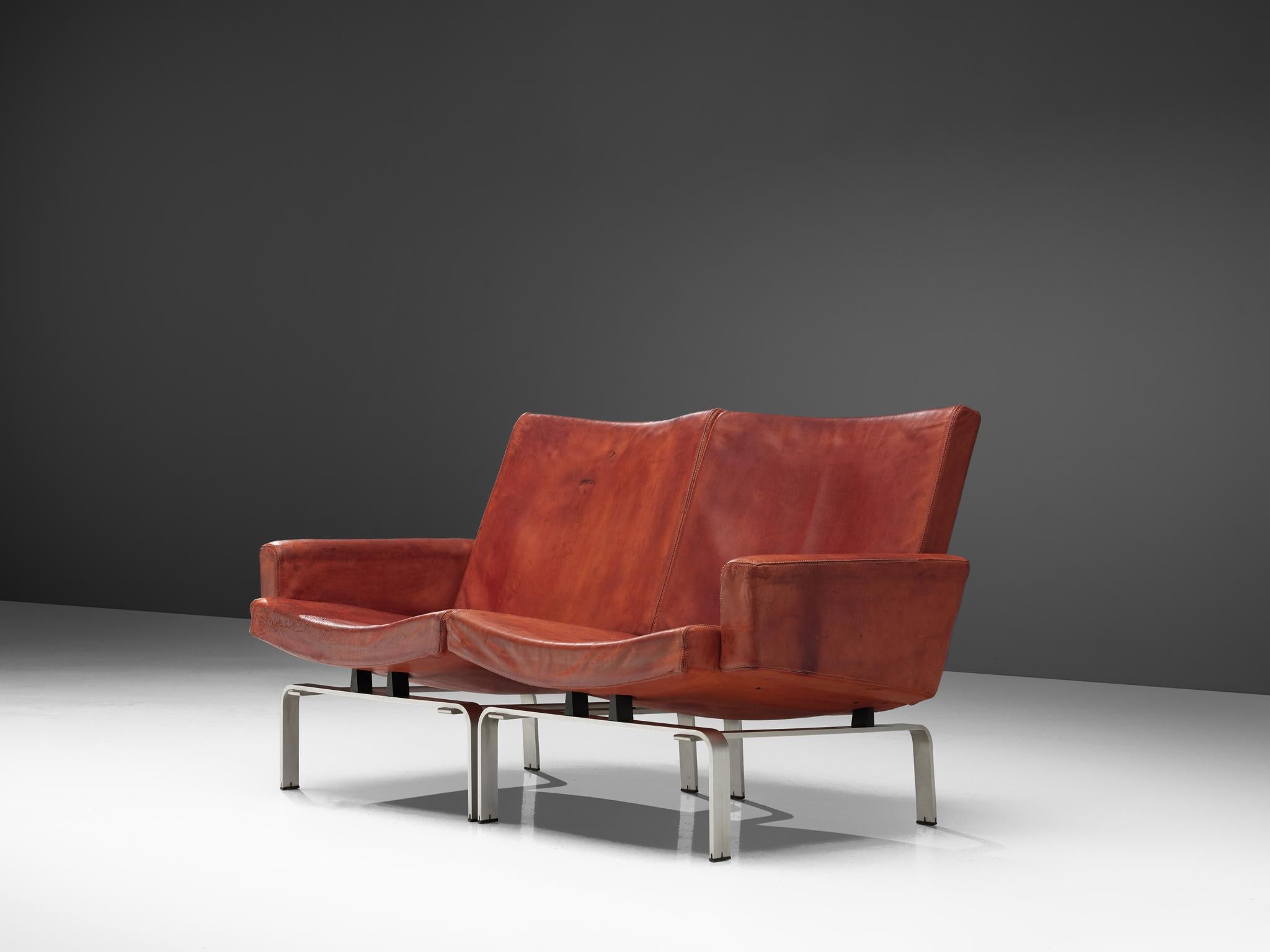 Jorgen Hoj for Niels Vitsoøe, settee, leather and aluminum, Denmark, 1963.

Exclusive cognac leather sofa designed by Jorgen Hoj who worked in the same atelier together with Poul Kjaerholm. The Sofa '202' manufactured by Niels Vitsoøe is supported