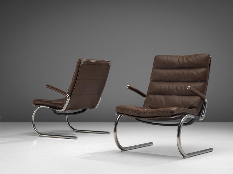 Jørgen Kastholm, pair of lounge chairs, metal and leather, Denmark, 1960s.

This modern pair of armchairs are executed in tubular steel and leather with an L-shaped seating. The legs and armrests form together an S-shape, which results in a