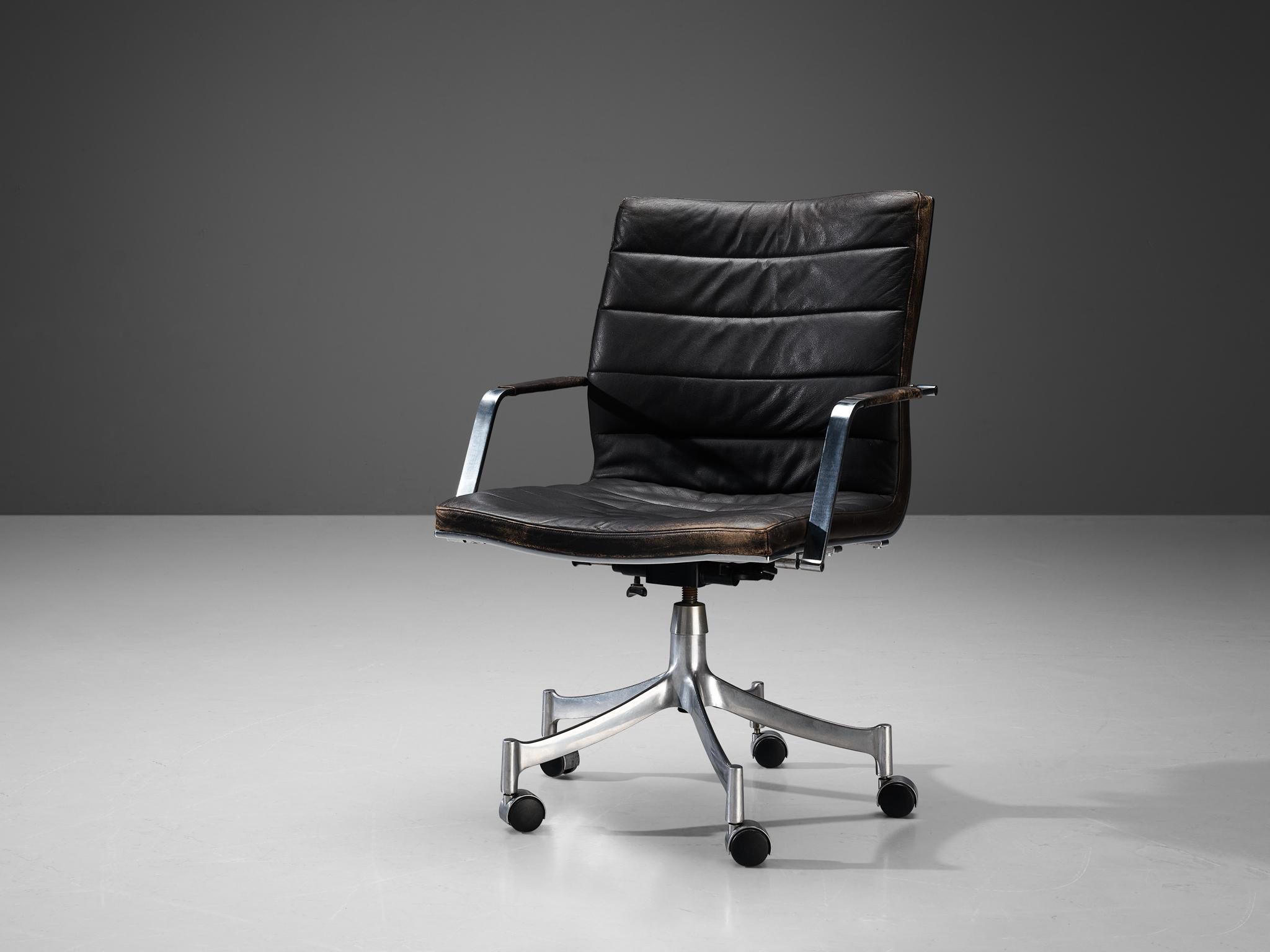 Jørgen Lund and Ole Larsen for Bo-Ex, swivel armchair model BO-854, leather, chromed steel, Europe, 1960s.

This comfortable and adjustable swiveling executive armchair is designed by Jørgen Lund and Ole Larsen for Bo-Ex. The chair is upholstered