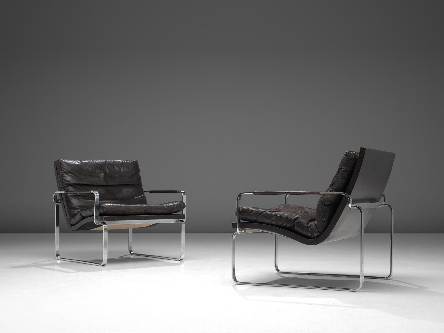 Jørgen Lund and Ole Larsen for Bo-Ex, pair of BO 911 armchairs, dark brown leather, chrome-plated steel, Denmark, 1960s

Two modern armchairs chairs in steel and leather. Not originally a set, due to small differences. An interesting detail is the