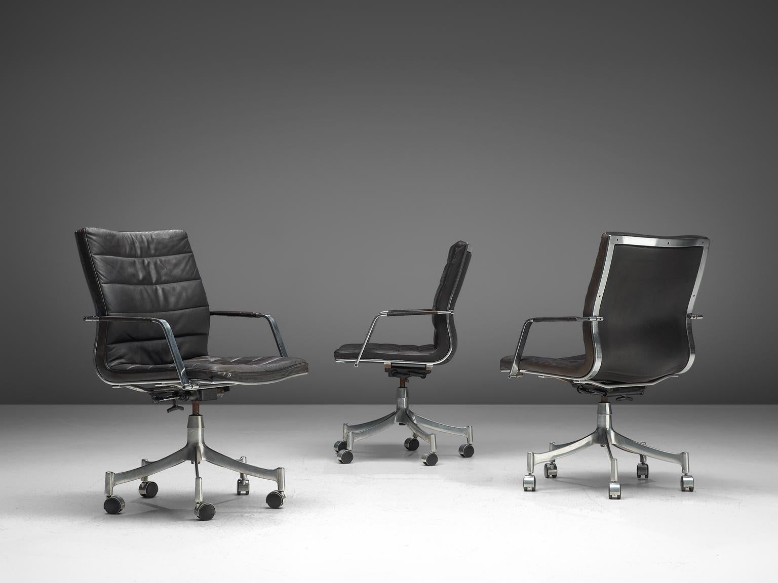 Jørgen Lund & Ole Larsen for Bo-Ex, set of three office chairs model BO-854, in leather and metal, Denmark, 1960s.

Modern office chairs in dark brown leather and brushed metal frame. These swivel chairs show great elegance. The five-legged base