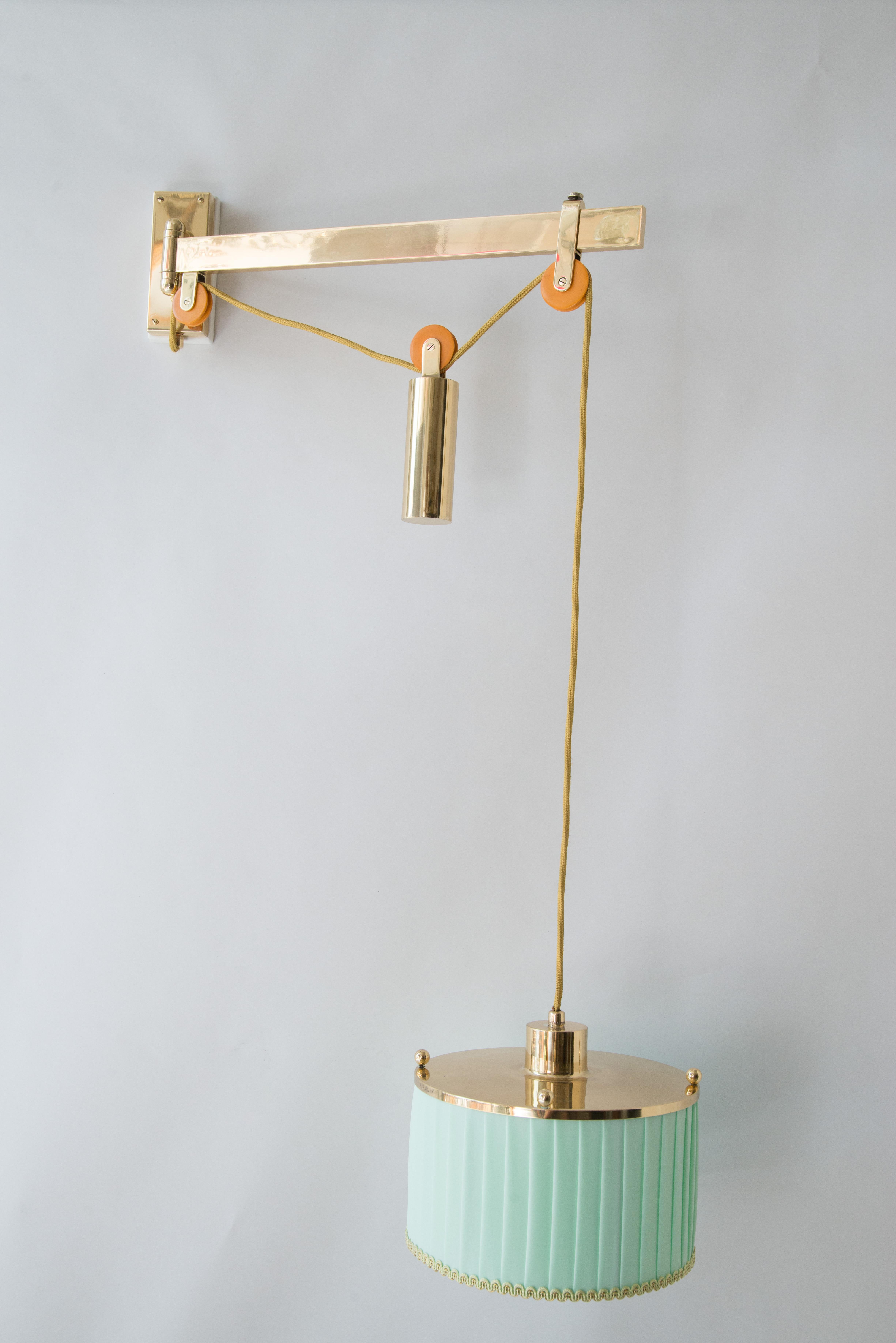 J.T. Kalmar adjustable wall lamp circa 1950s.
Polished brass 
Stove enameled 
Everything is original only the fabric and the wire is replaced.
The high is extendable from 58cm up to 87cm.
