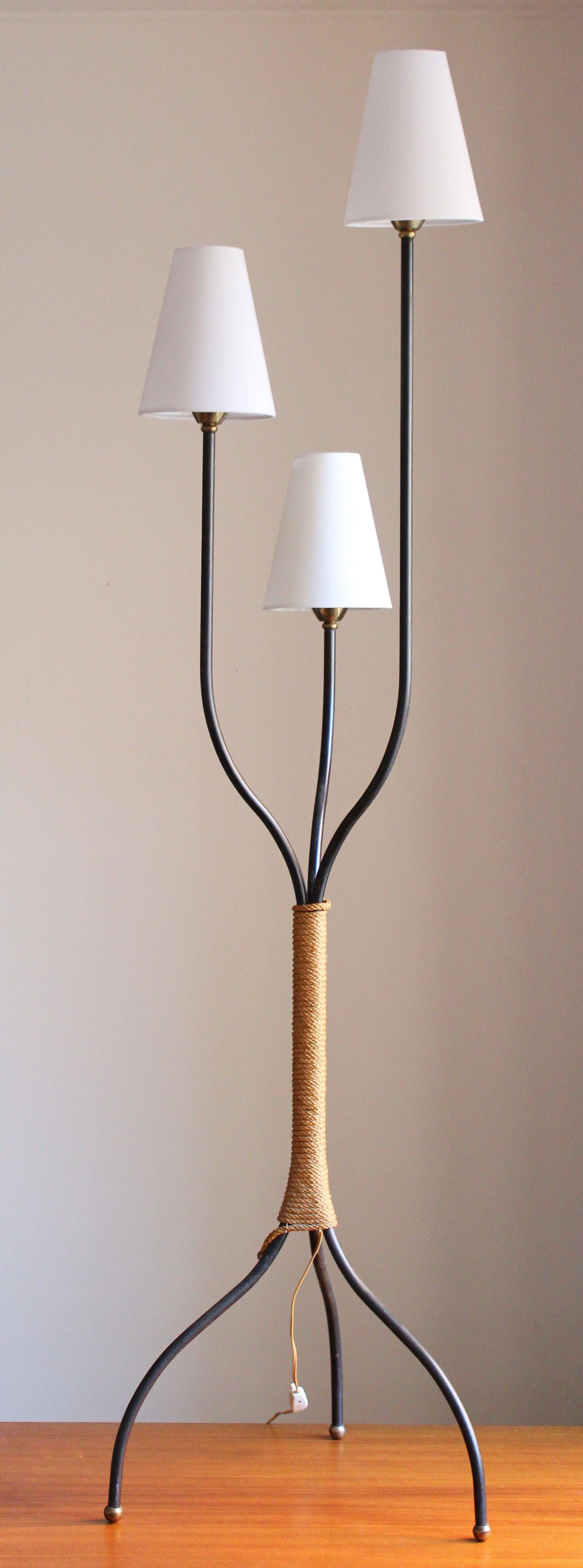 An organic floor lamp, in black lacquered metal, wrapped in cord with brass ends and brass feet. Designed and production attributed to J.T. Kalmar, Austria, 1950s.

With brand new high-end lampshades.

Other designers of the period include Paavo