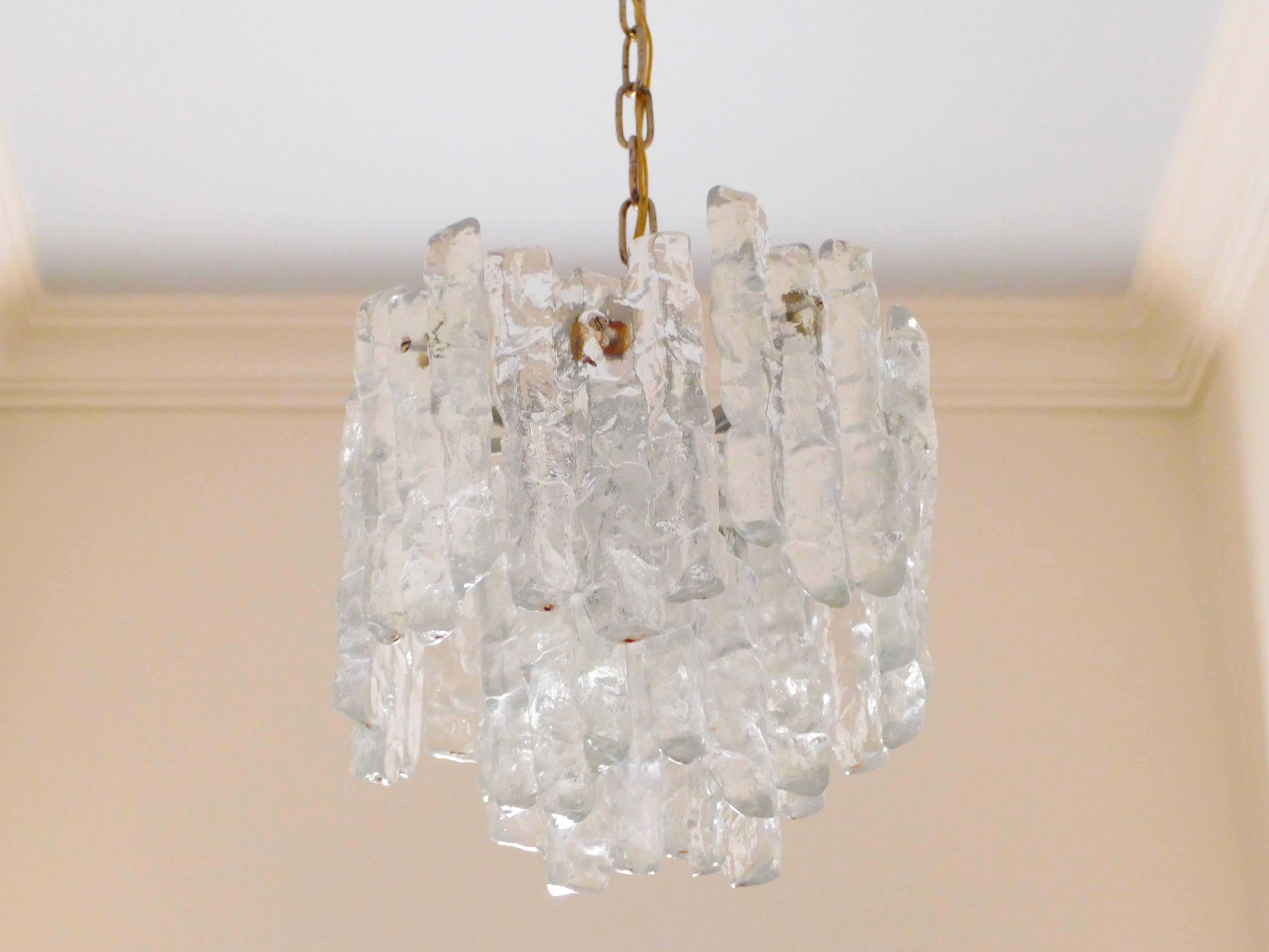 J.T. Kalmar, a prominent early to midcentury Austrian designer, designed this chandelier to look like icicles formed from pure water. The highly crafted piece has a sophisticated and intricate look that surprises with its warm glow when lighted.