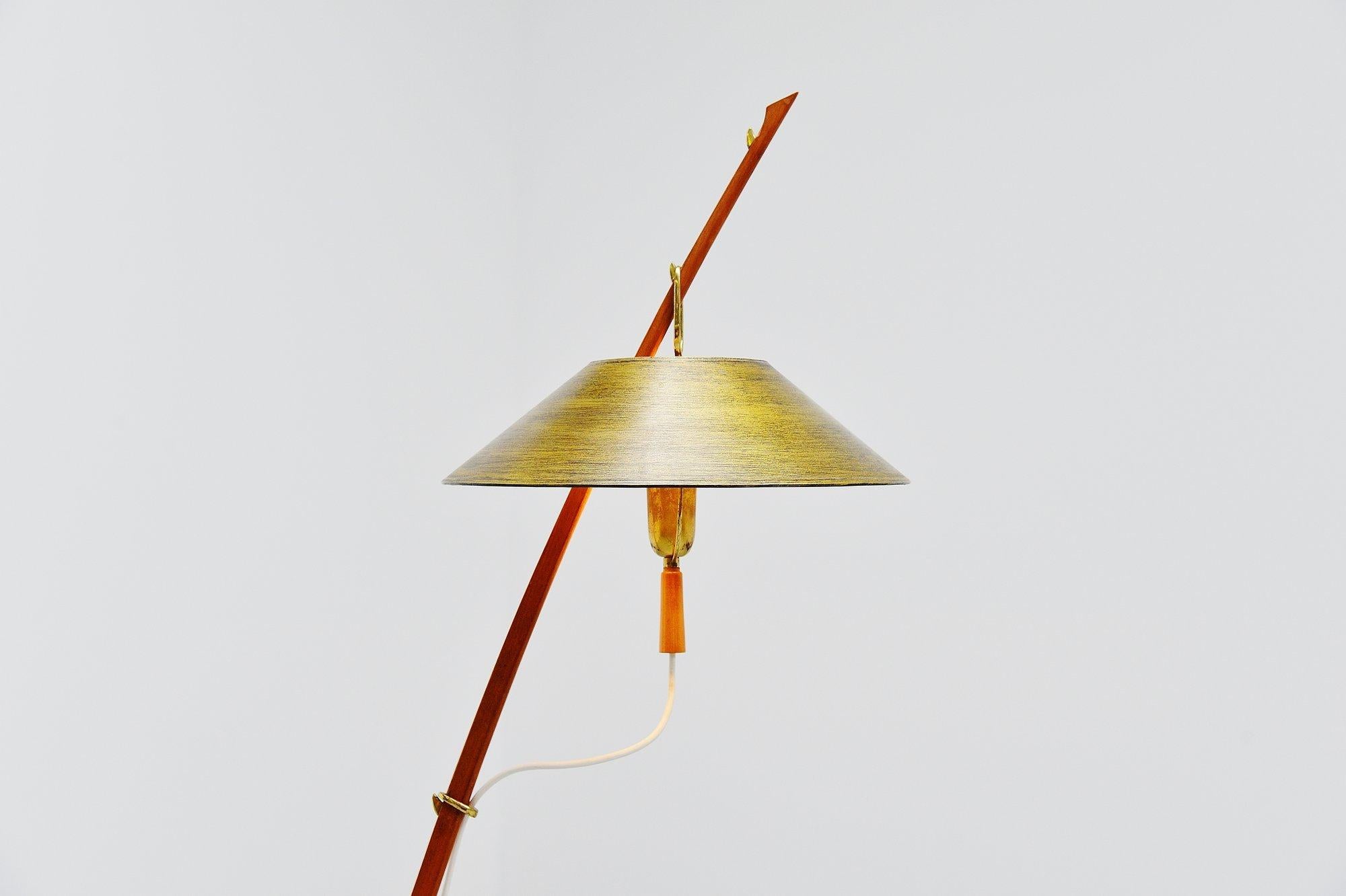 Very nice shaped floor lamp by J.T. Kalmar and manufactured by Kalmar, Austria 1950. This floor lamp has a teak frame and brass foot, it has a gold colored paper shade which is adjustable in height. The lamp is in excellent original condition. Lamp