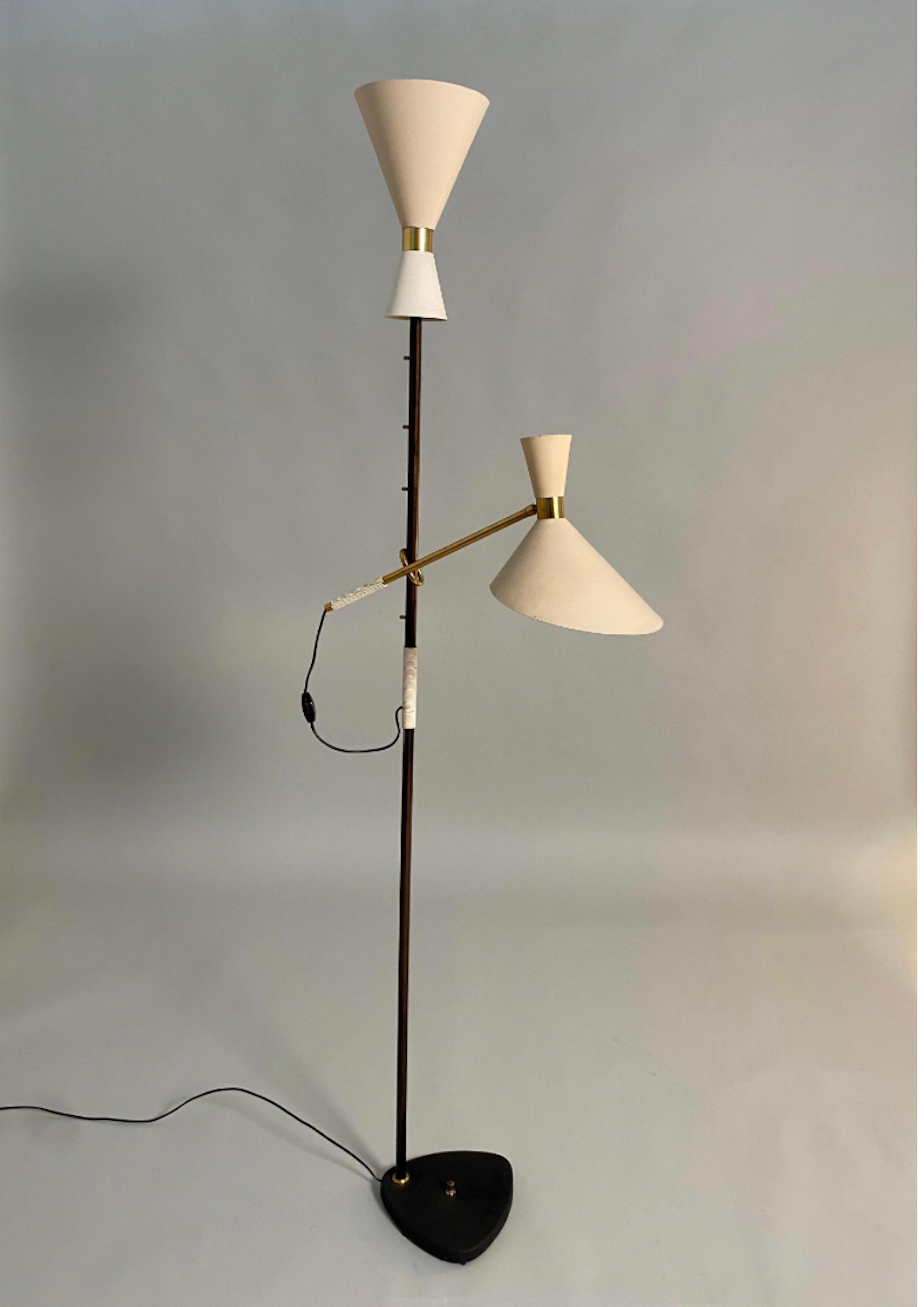 Pelikan floor lamp, mod. 2097, by the Austrian designer J.T. Kalmar. Black lacquered cast base and stem with brass details. The taupe shade on the brass arm is adjustable in five positions. Wear consistent with age and use, minor scratches and lost
