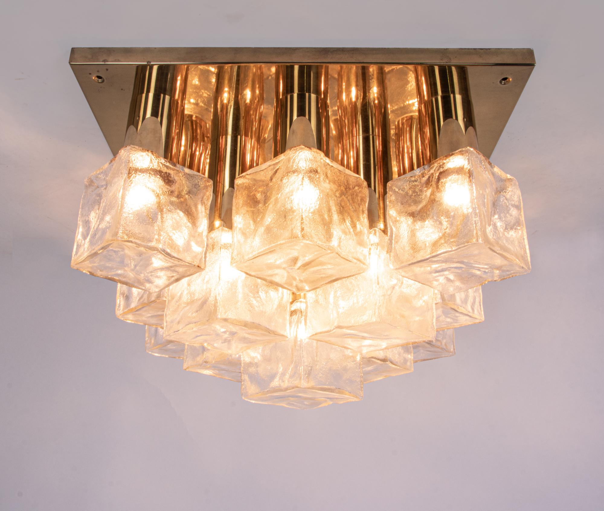 Elegant flush mount ceiling light with 13 ice glass cubes on a golden brass frame. Manufactured by J.T. Kalmar, Austria in the 1960s. 
  
Measures: width total 18.1” in. (46 cm), depth 18.1” in. (46 cm), diameter frame only 11.8” in. (34 cm).