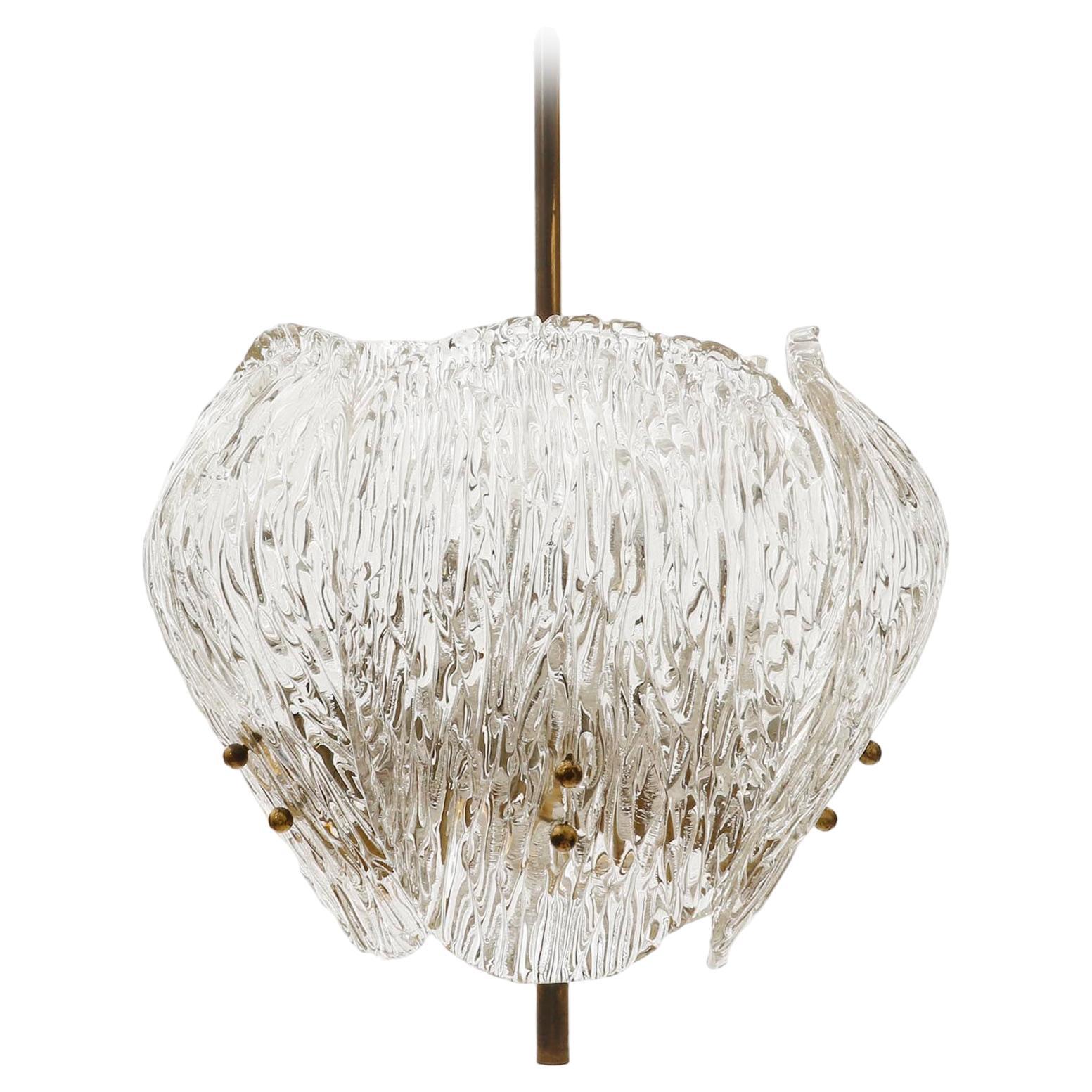 A beautiful light fixture by J.T. Kalmar, Austria, manufactured in Mid-Century, circa 1960 (late 1950s to early 1960s). 
It is made of five pressed and textured glass pieces in the form of shells or clams and solid polished brass with an aged
