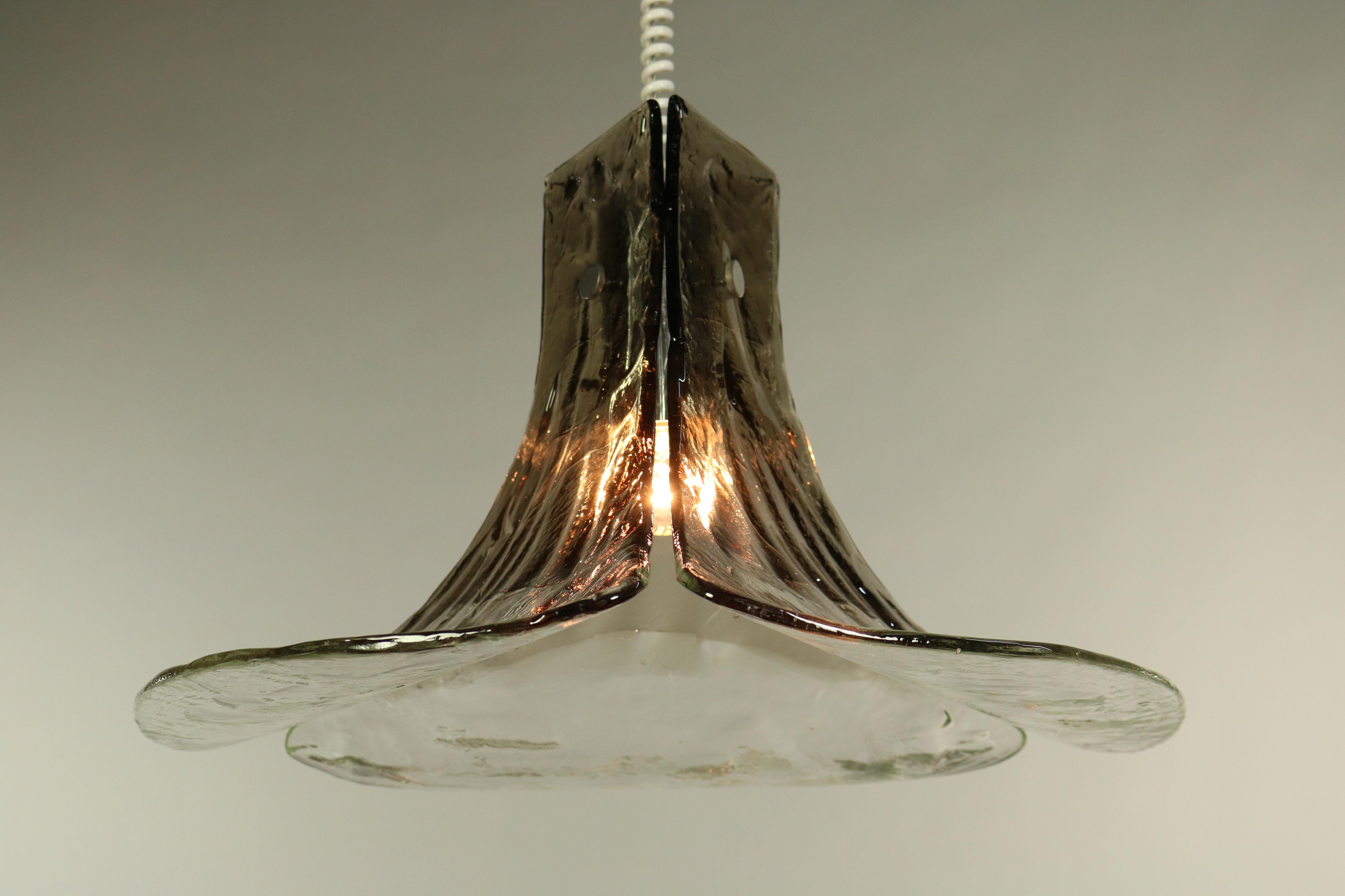 A three leaf shade of thick walled handblown glass 
is mounted to this spectacular chandelier
the design of the individual glass parts reminds to the shape of the leaves of the gingko biloba tree
which was very fashionable in Europe circa
