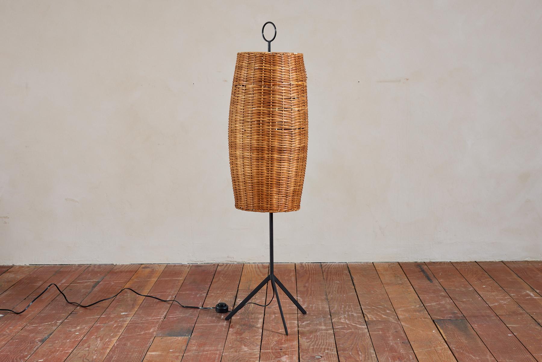 Floor Lamp by J.T. Kalmar with black iron tripod base and woven rattan vessel with circle shaped finial. 

Austria, 1960's 

Newly rewired 

