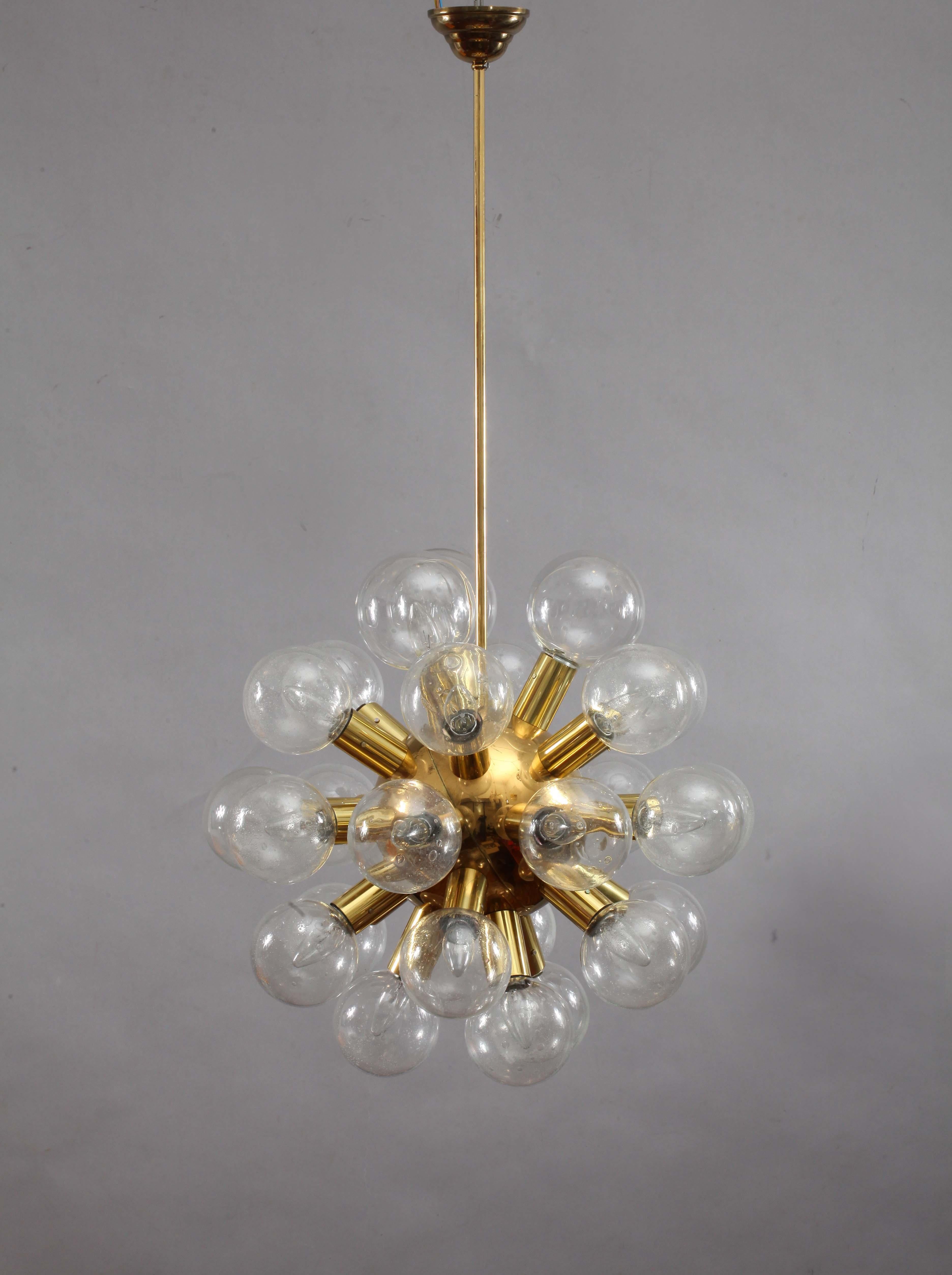 One 27-arm atomic chandeliers or pendant lights model 'RS 27 Kugel HL' by J.T. Kalmar, Austria, manufactured in midcentury, circa 1970 (late 1960s or early 1970s).
They are made of polished brass and 27 hand blown bubble glass lamp shades with a