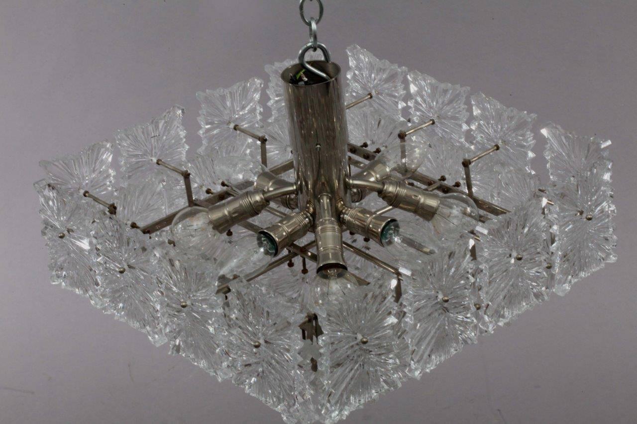 ceiling flush mount,
J.T.Kalmar,
Austria 1970.
chrome frame, many glass parts.
eight E 14 bulb sockets
2 fitting wall scounces also available!
The length of the stem can be altered to any size for free