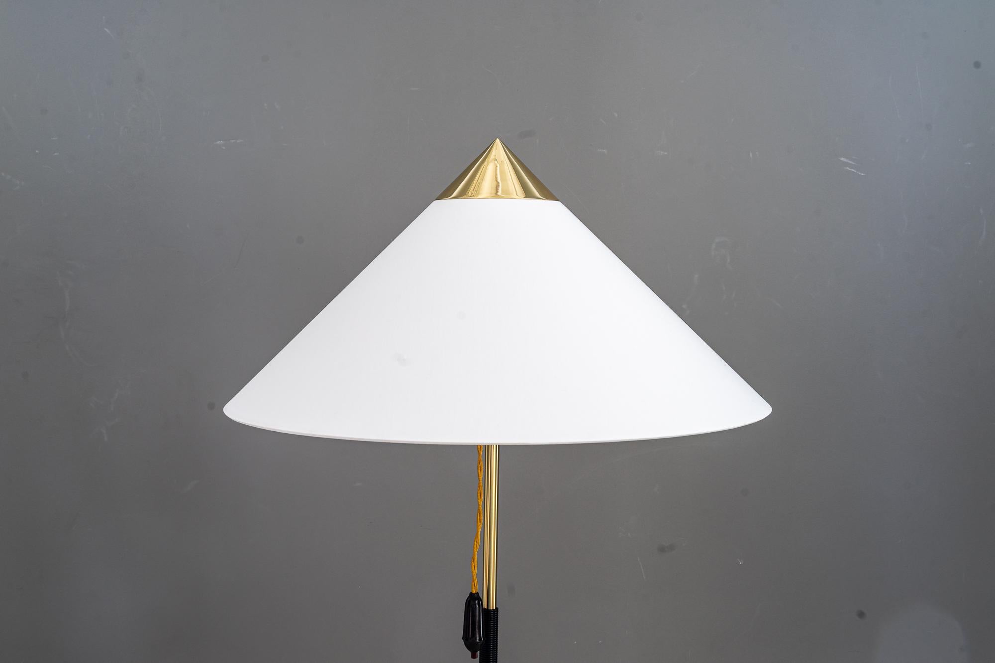 J.T.Kalmar floor lamp with fabric shade around 1950s 
Brass polished and stove enamelled
The fabric shade is replaced ( new ).